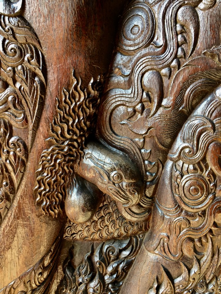 The doors to the main building have intricate carvings of demons with animal-headed penises like the eagle seen here