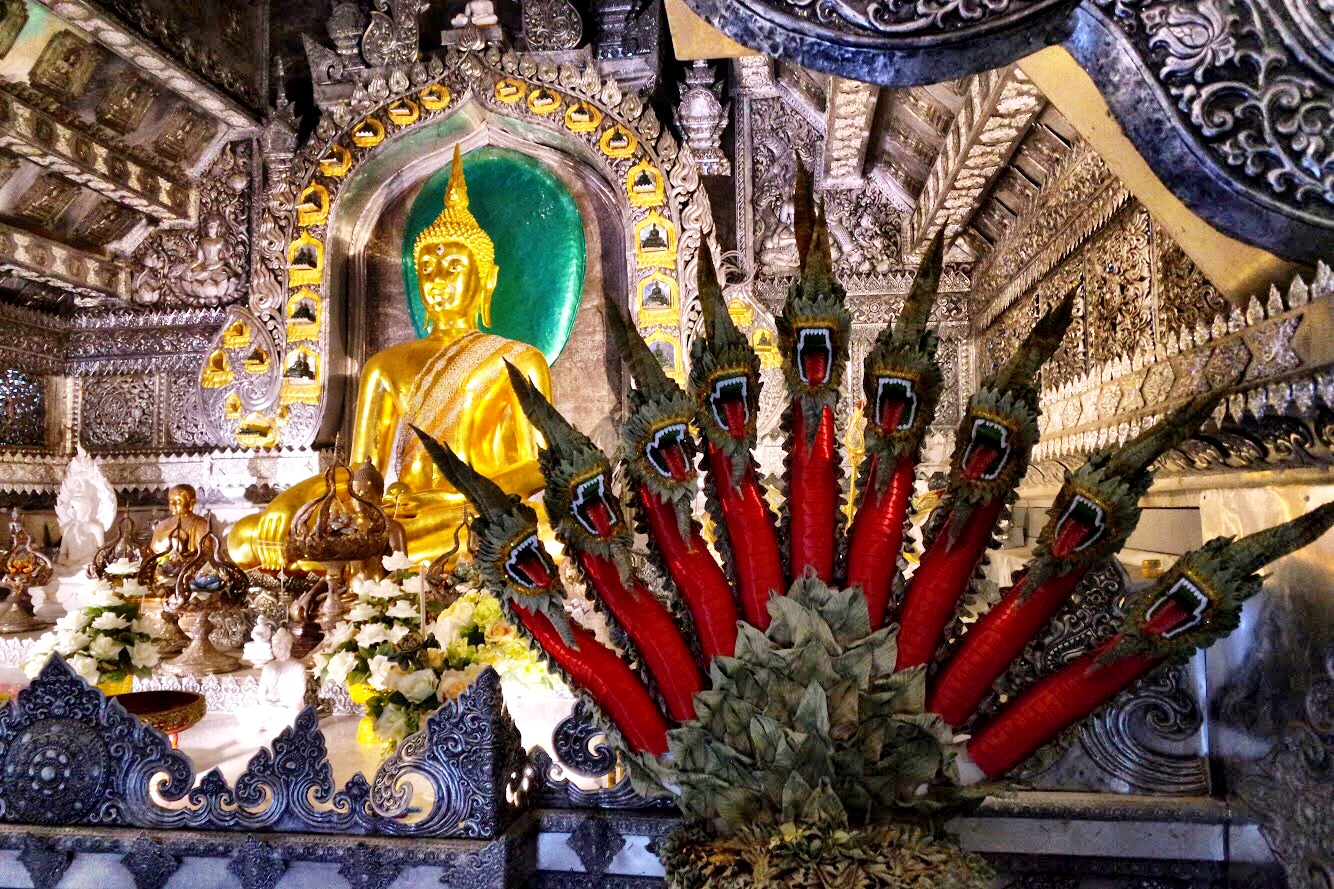 The Buddha image in the ubosot, the main ordination hall with an angry naga fan