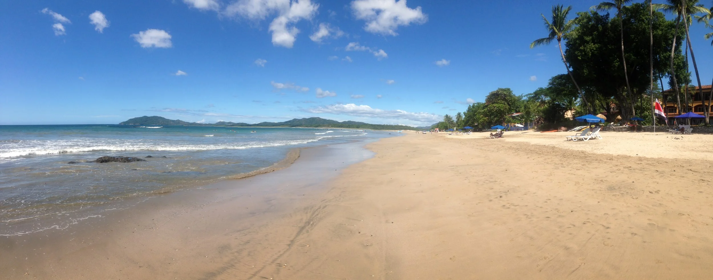 Tamarindo Beach, where anyone looking to surf for their first time should head to — it has the most consistent, entry-level waves you can find. This photo is also very typical looking for most beaches in Costa Rica