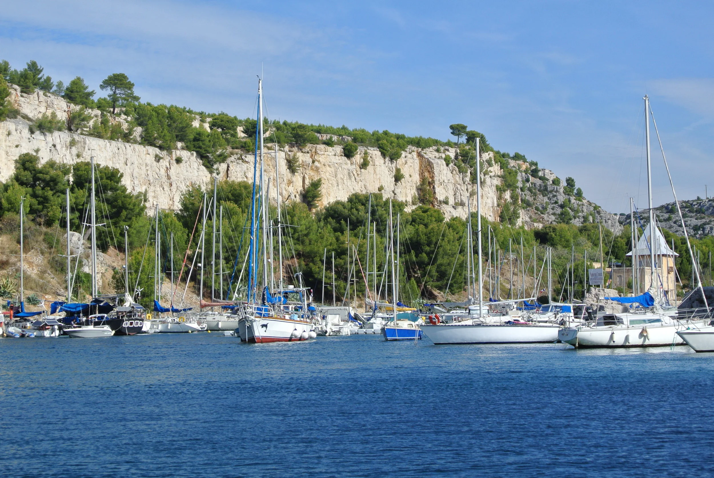 The Port of Cassis on the French Riviera, with its pretty backdrop of the limestone cliffs called calanques