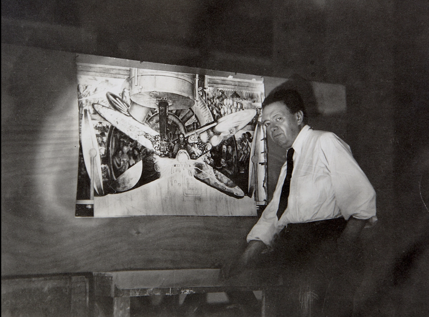 Diego Rivera stands by a study of the mural Man at the Crossroads, which was commissioned by Rockefeller