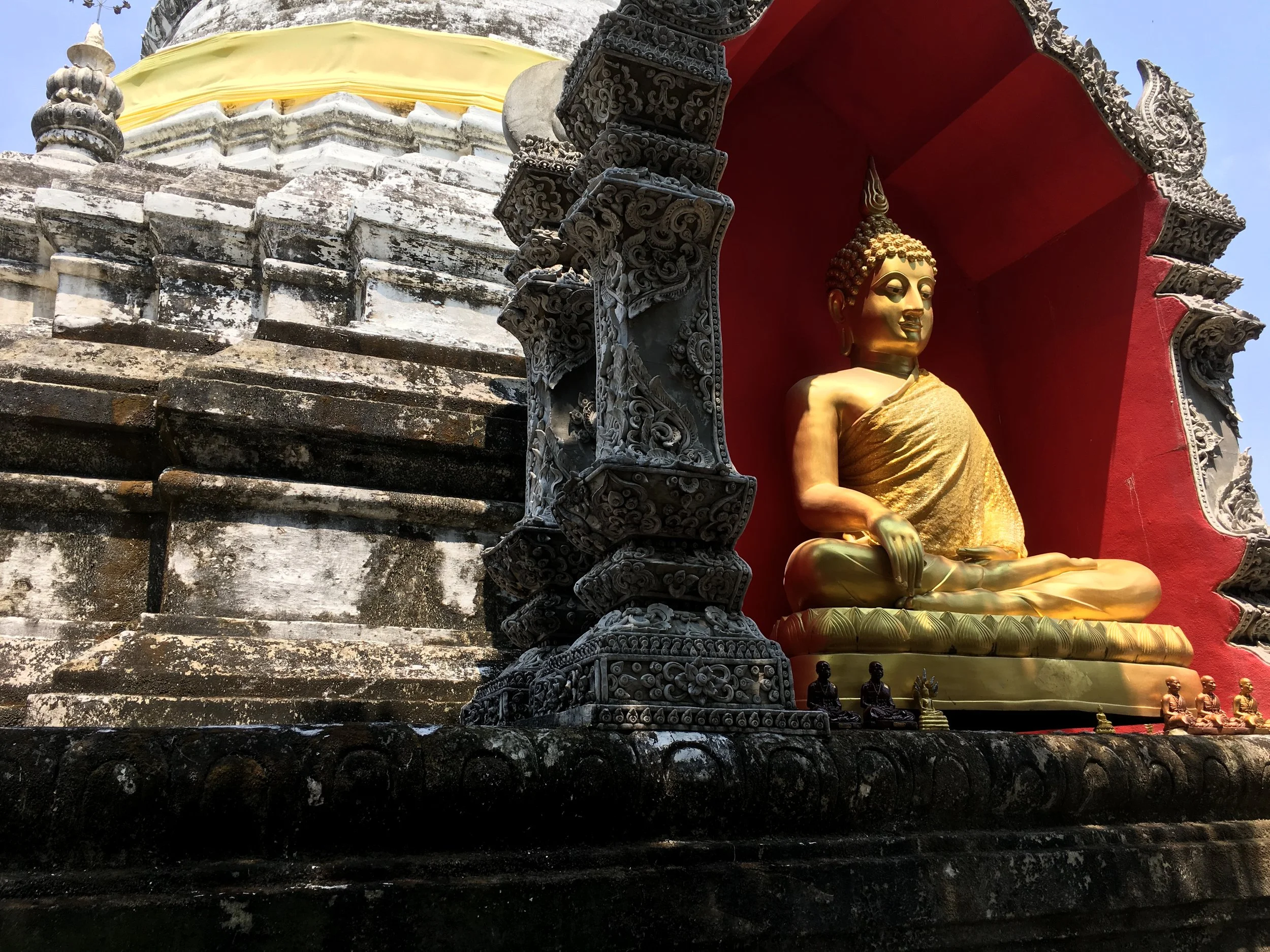 A Buddha inside a niche at the chedi of Wat Buppharam