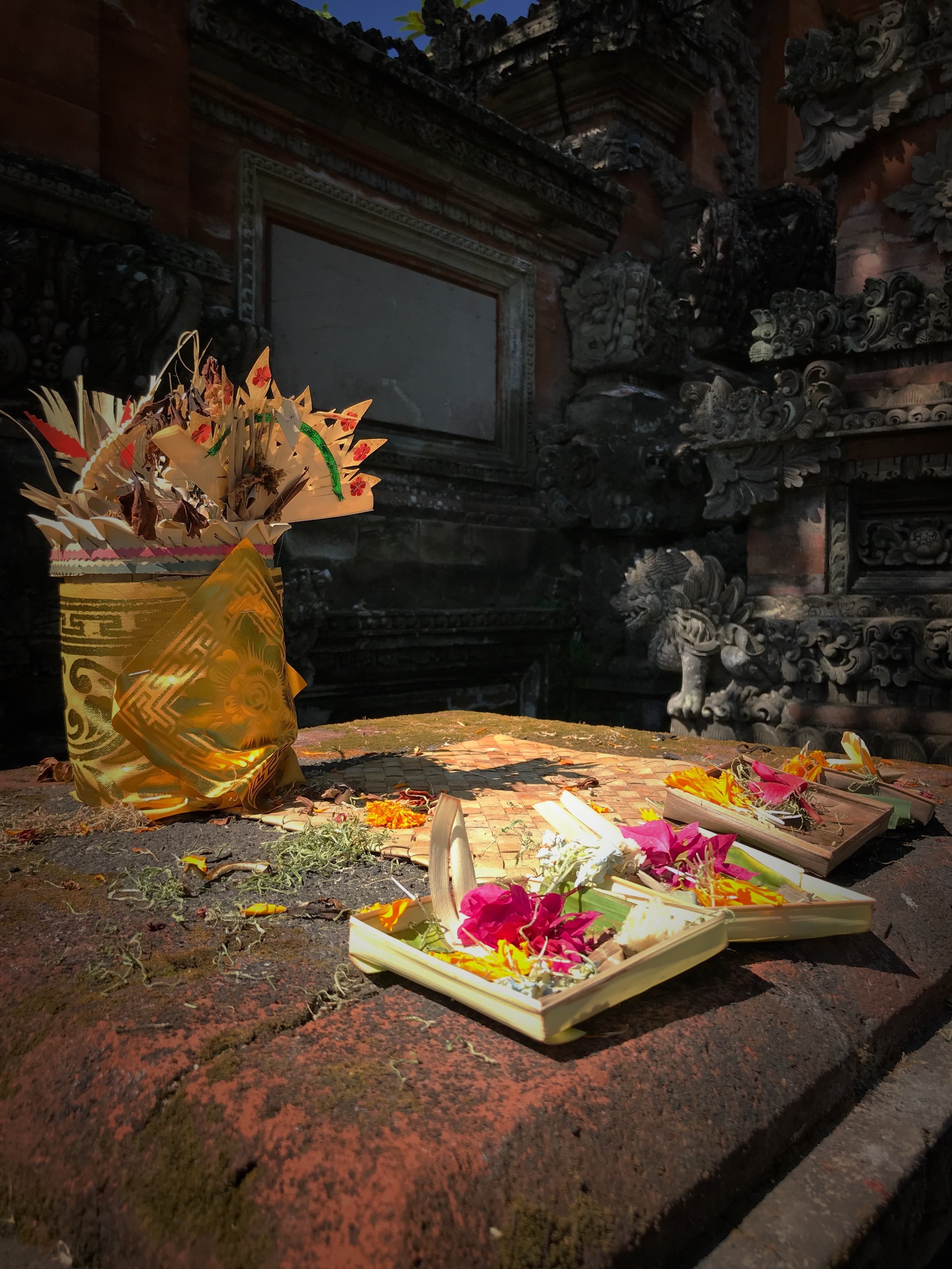 People leave offerings of flowers for Saraswati