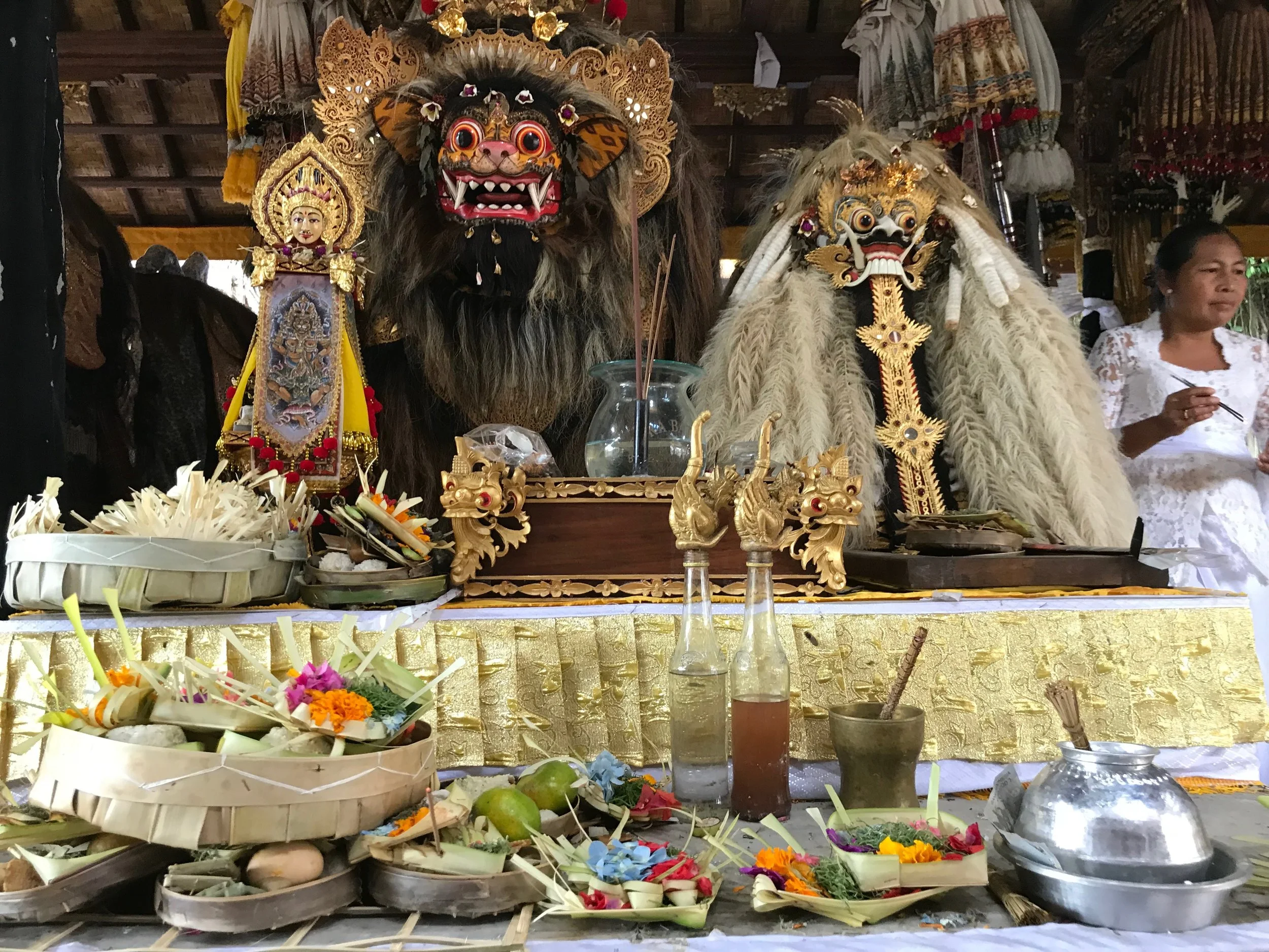 The Hindus of Bali offer flowers and fruit to thank Barong for protecting them. The mask on the left is the form of a macan, or tiger