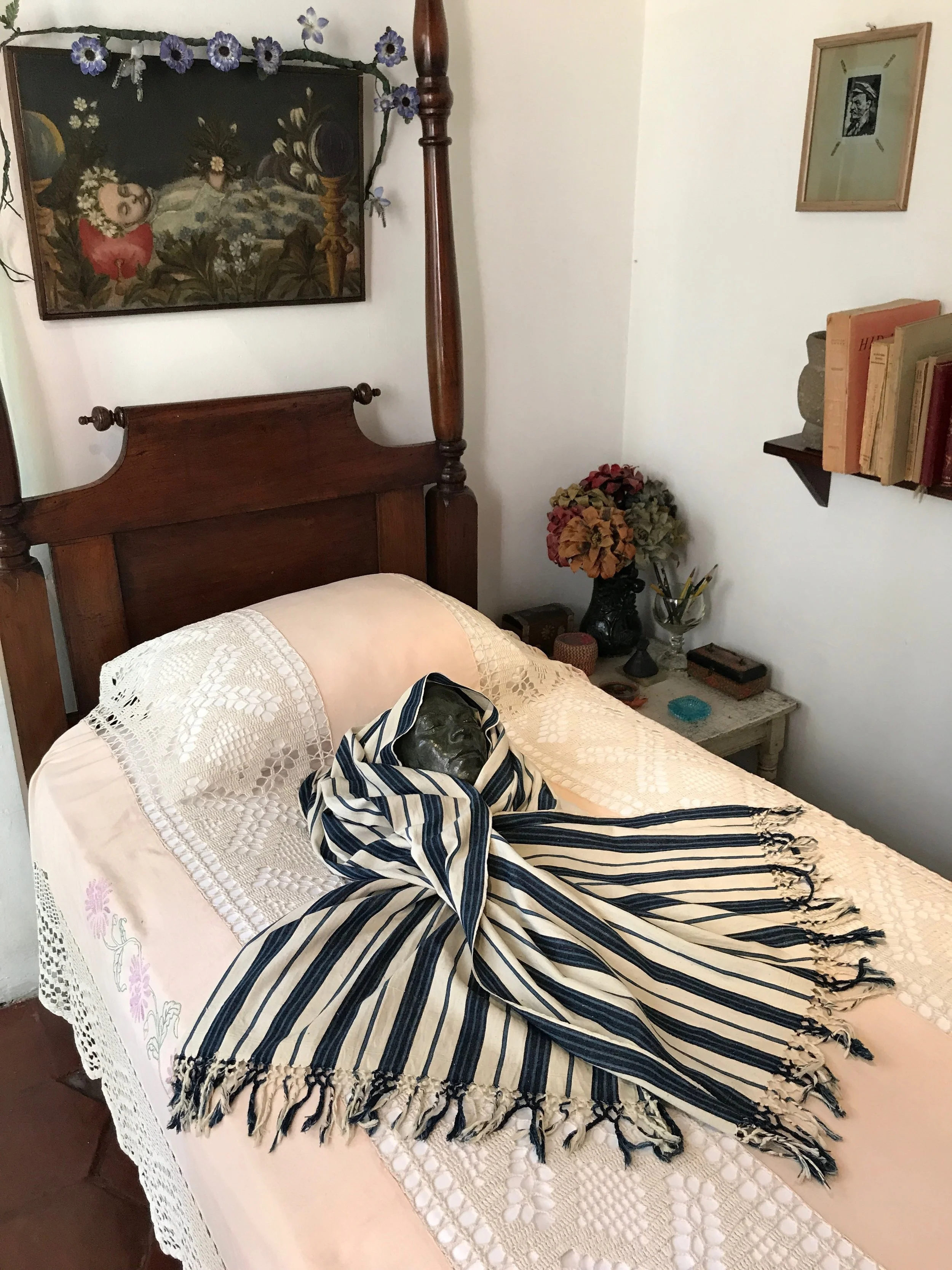 Frida’s death mask sits on her bed