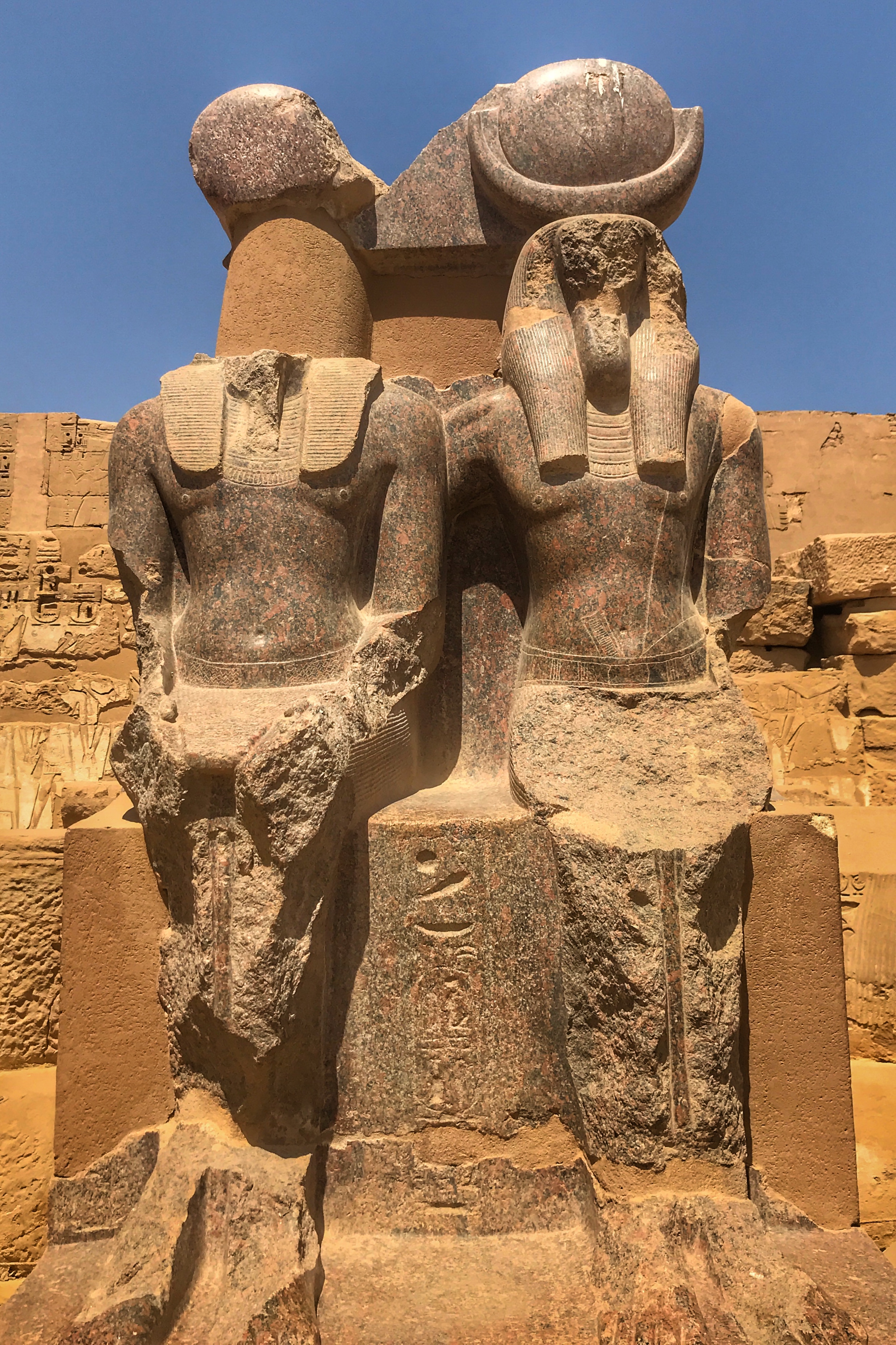 There are four rose granite statues at the very back of the complex. They depict Ramesses III with Maat, the goddess of truth and justice, and Thoth, the god of wisdom