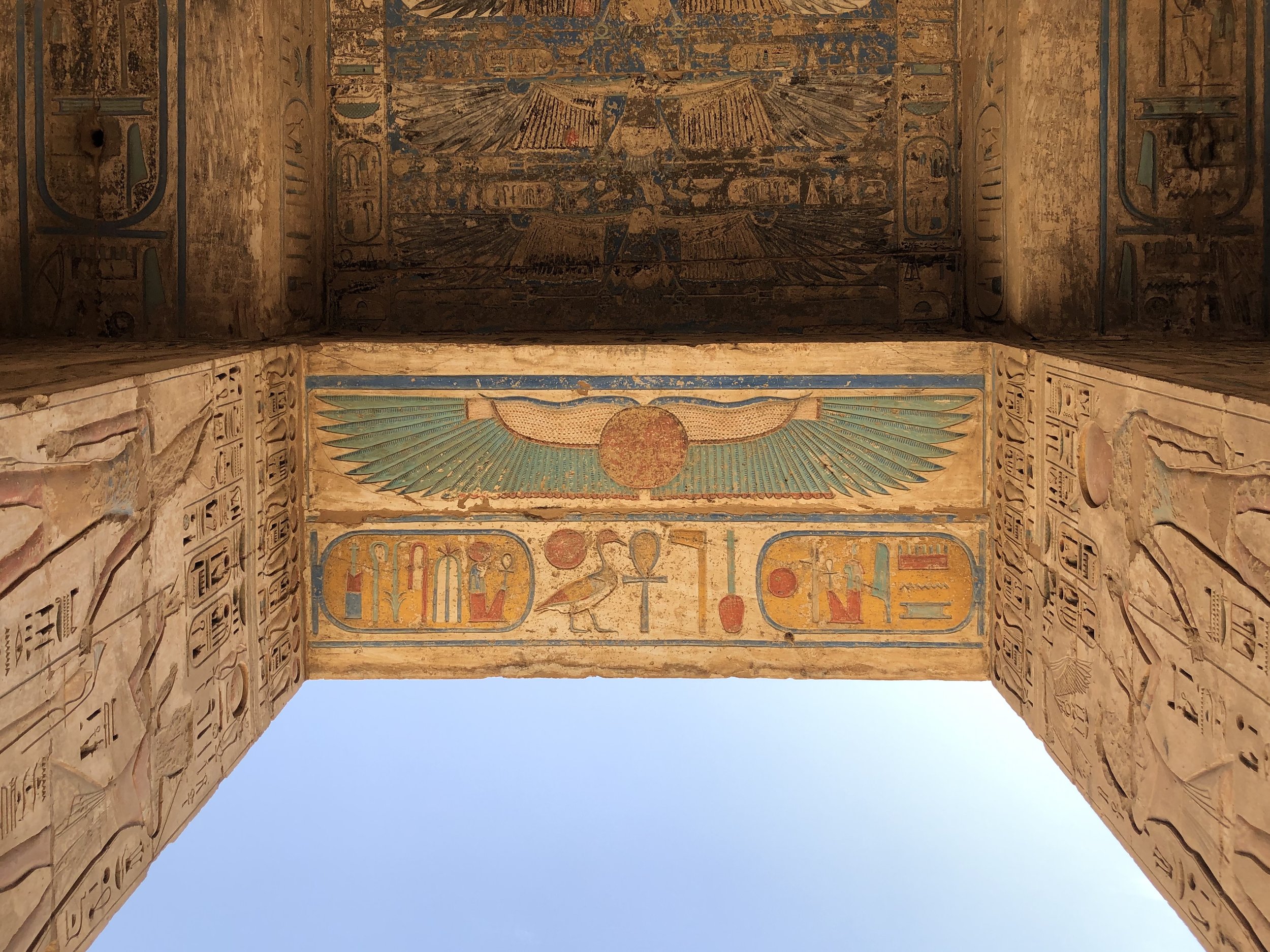 The underside of this gateway shows the winged sun amongst other paintings