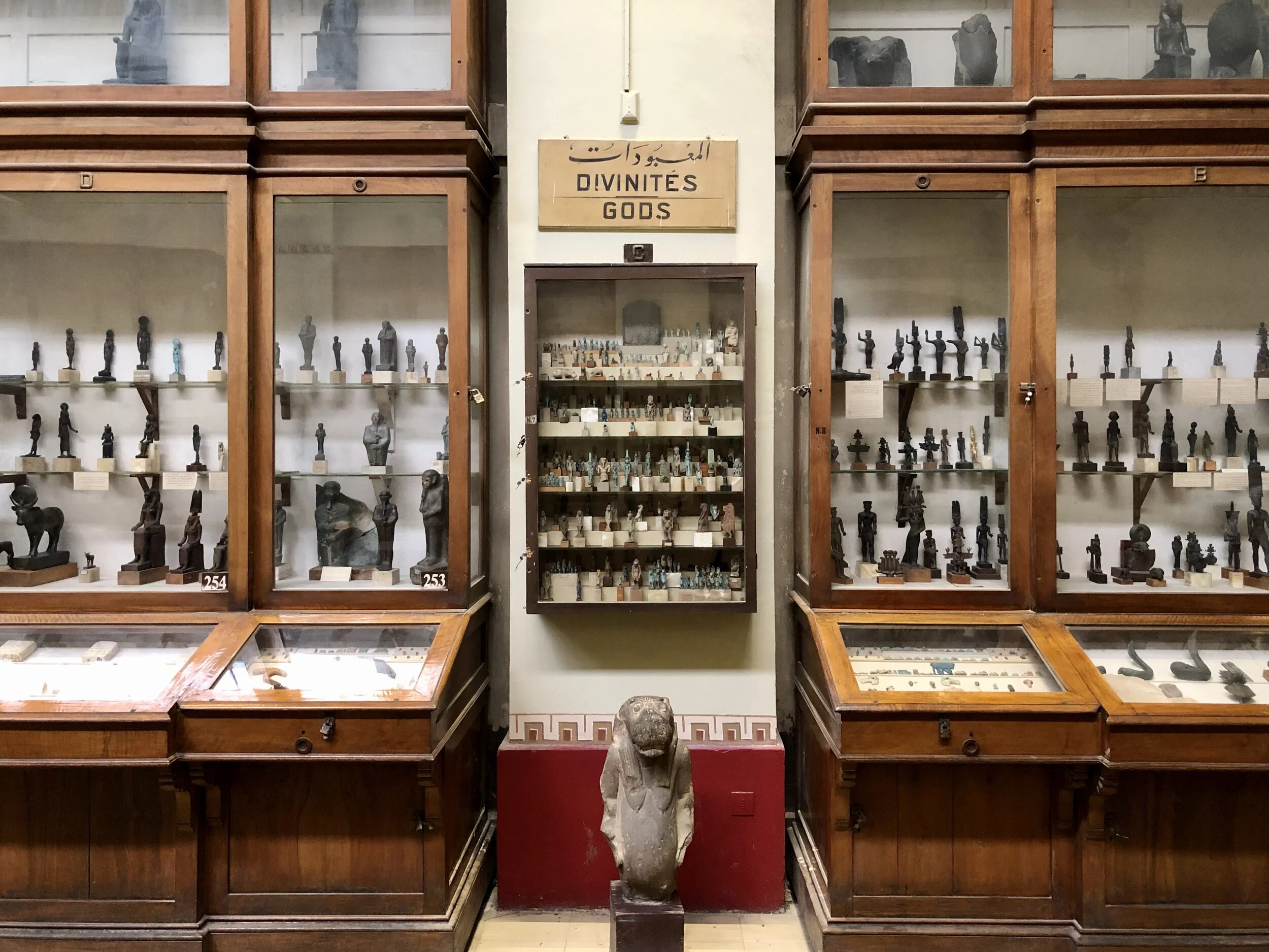Rows of figurines of gods and goddesses sit tucked away in vitrines — some labeled, some not