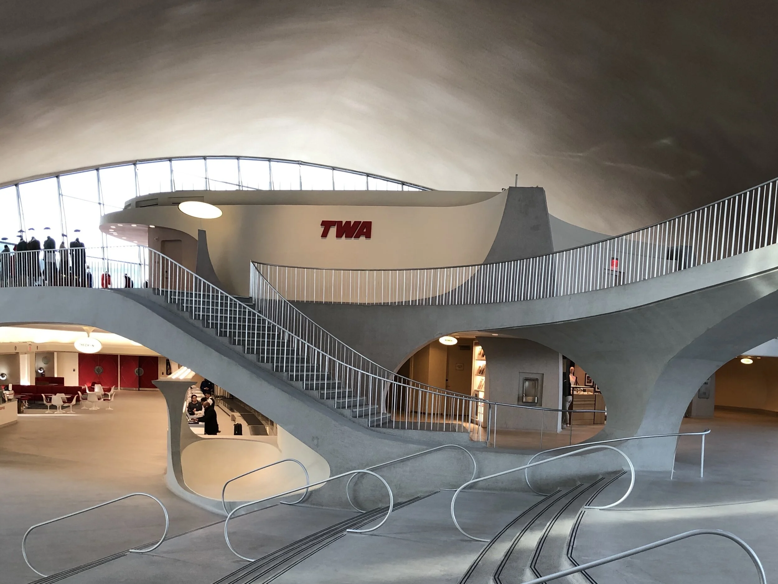 Swooping staircases and curving walkways fill the interior.