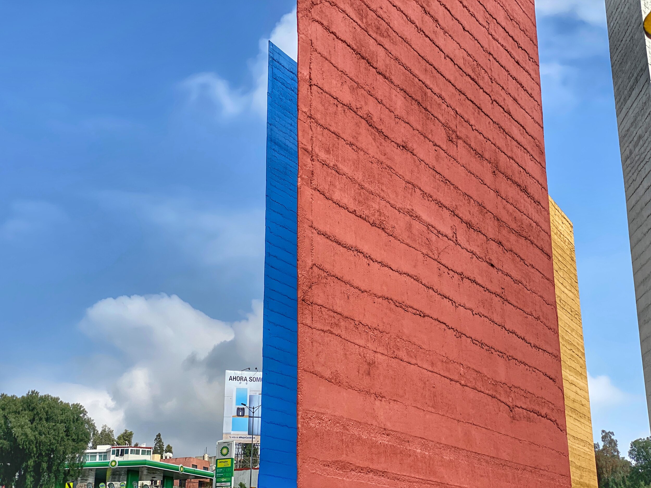 The towers are in a concrete median in the middle of a bustling freeway, with commercial developments on either side. Note how Barragán ingeniously positioned the structures so their angles align at various vantage points.