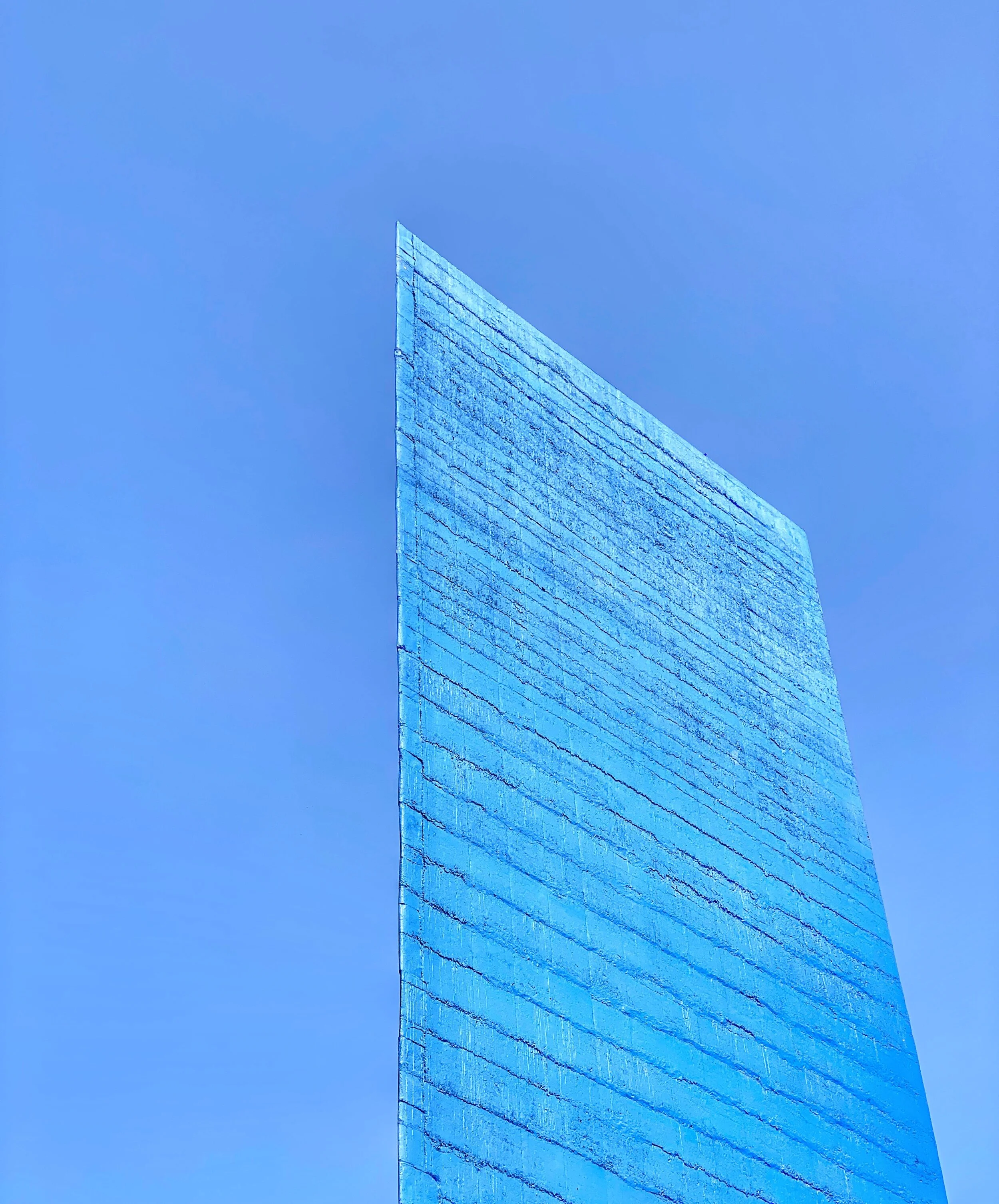 Note the forced perspective — the horizontal lines get closer and closer as they near the top. This makes the tower look taller that it really is. The blue was chosen to match the sky.