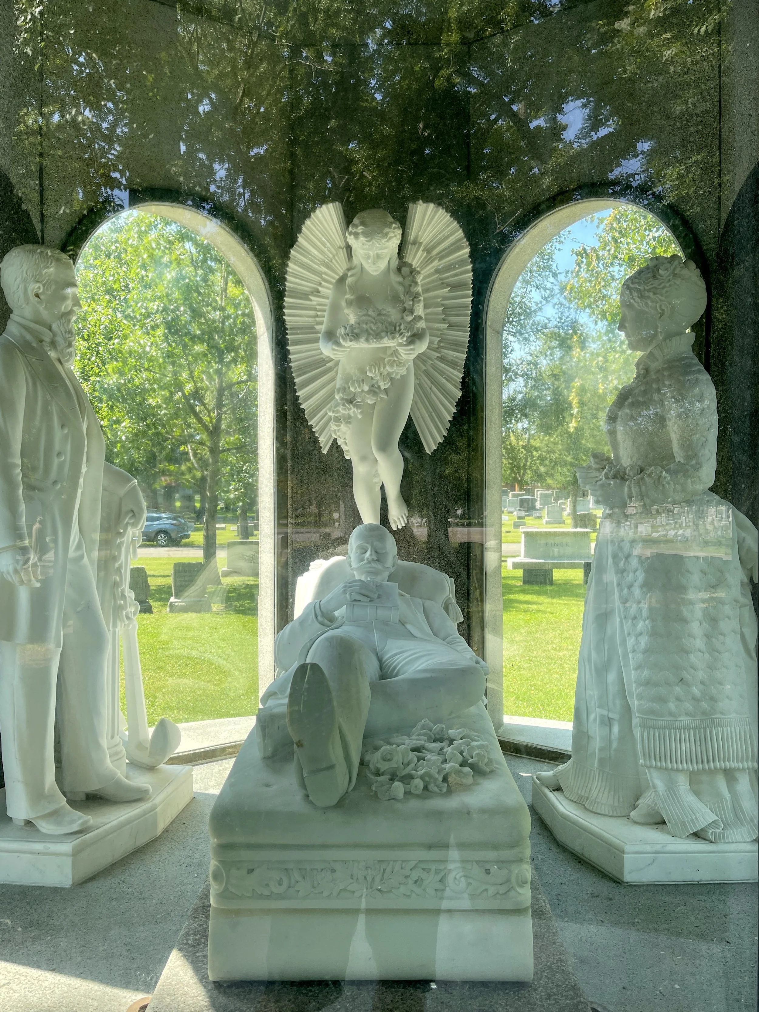 Inside the Blocher Monument at Forest Lawn, statues of the dead man, his parents and an angel