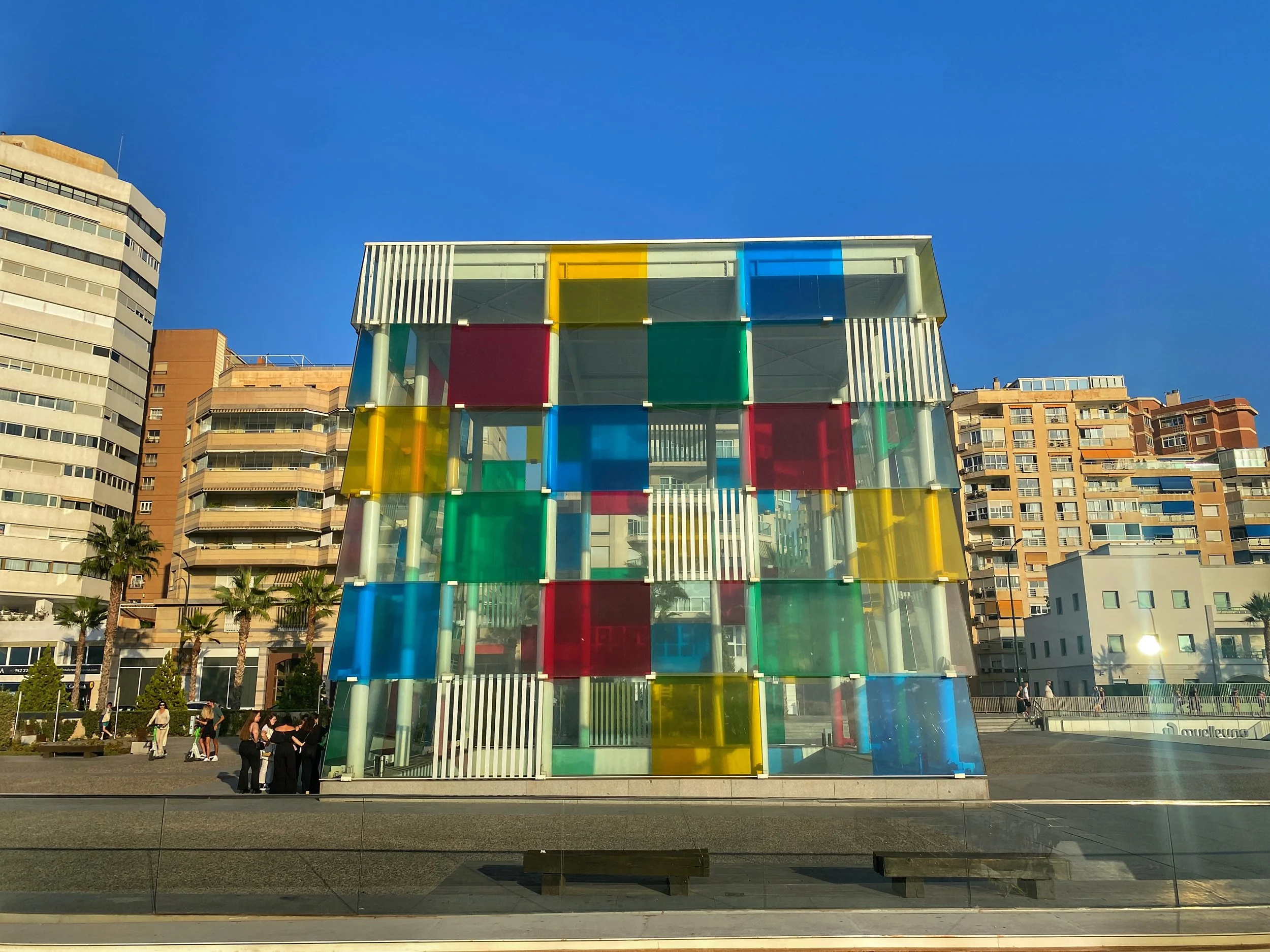 Red, yellow, blue and green transparent squares cover the cube-shaped entrance to the Centre Pompidou Malaga in the city's port