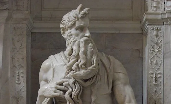 Top of a statue of Moses showing his long beard and the horns he got after seeing God