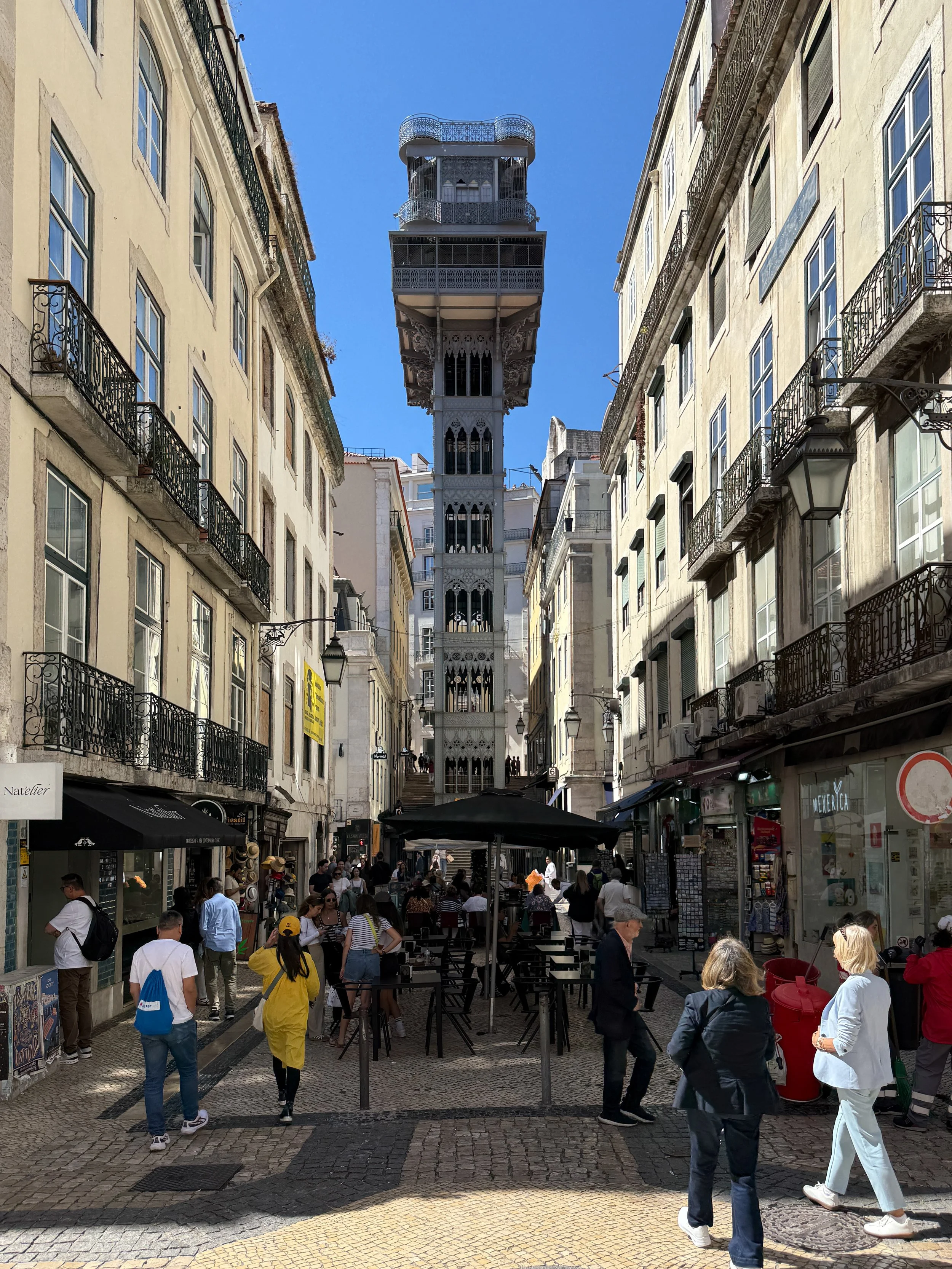 People pass by the Neo-Gothic Elevador de Santa Justa in the Baixa neighborhood of Lisbon, Portugal
