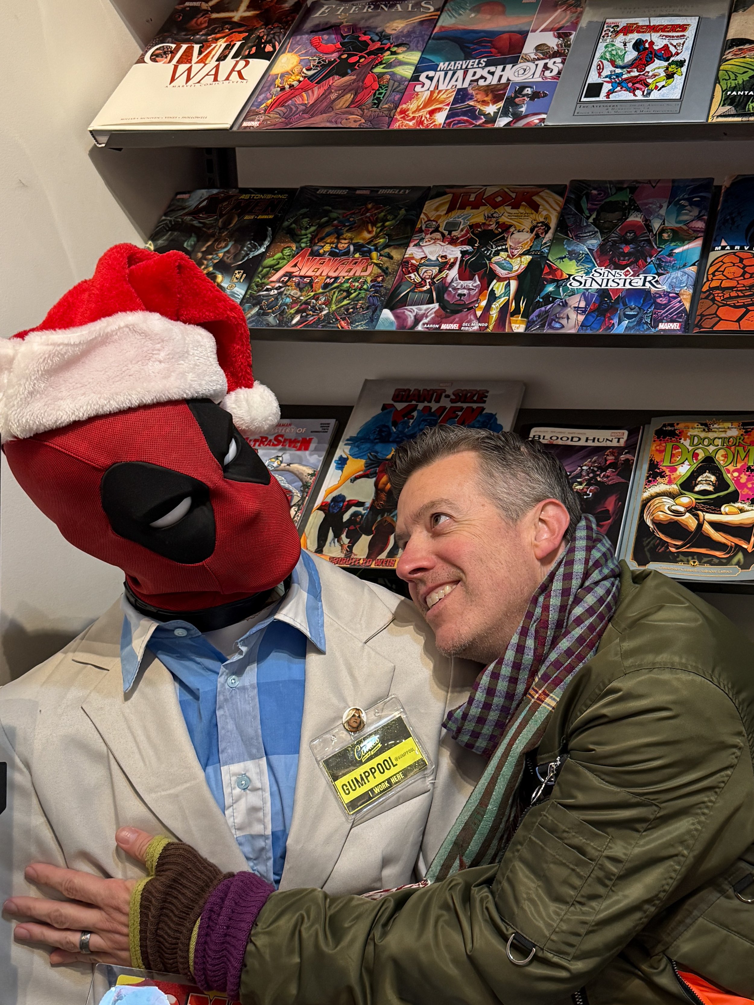 Wally gazes lovingly up at Deadpool dressed as Forrest Gump, in Neighborhood Comics in Savannah, Georgia