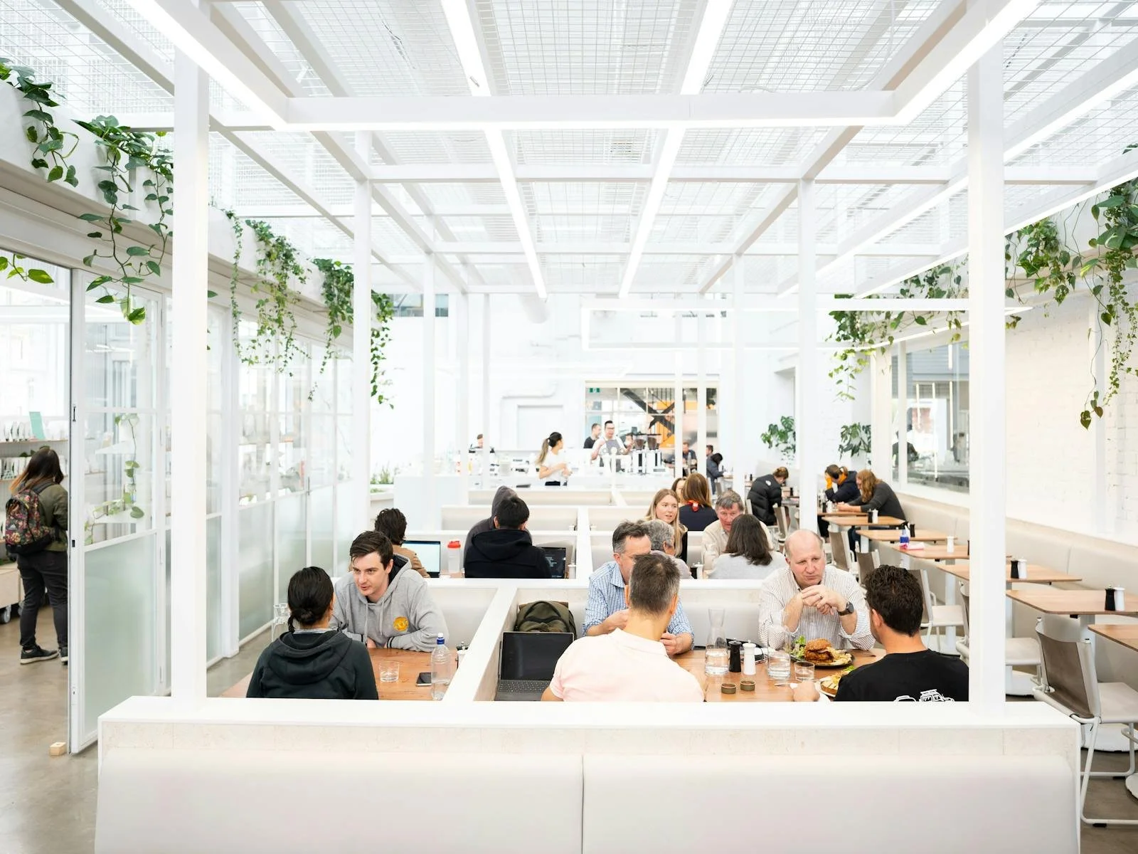 White modern designed booths filled with patrons at Industry Beans in Melbourne, Australia