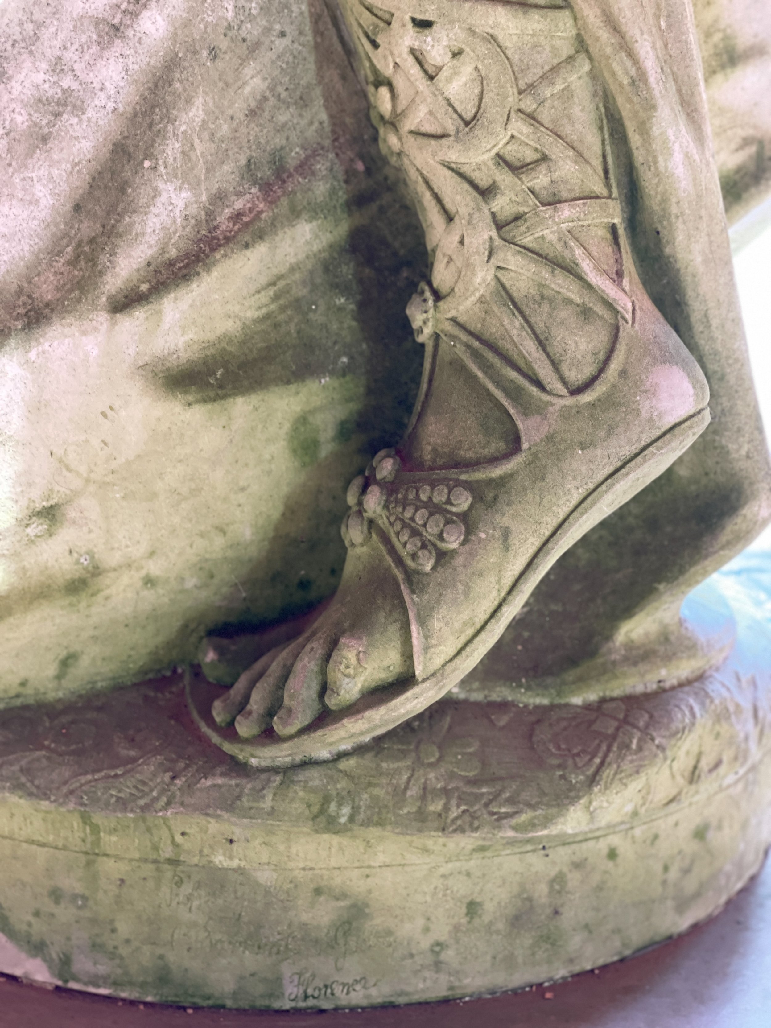 Closeup of sandalled foot on statue in the loggia at the Vanderbilt Mansion