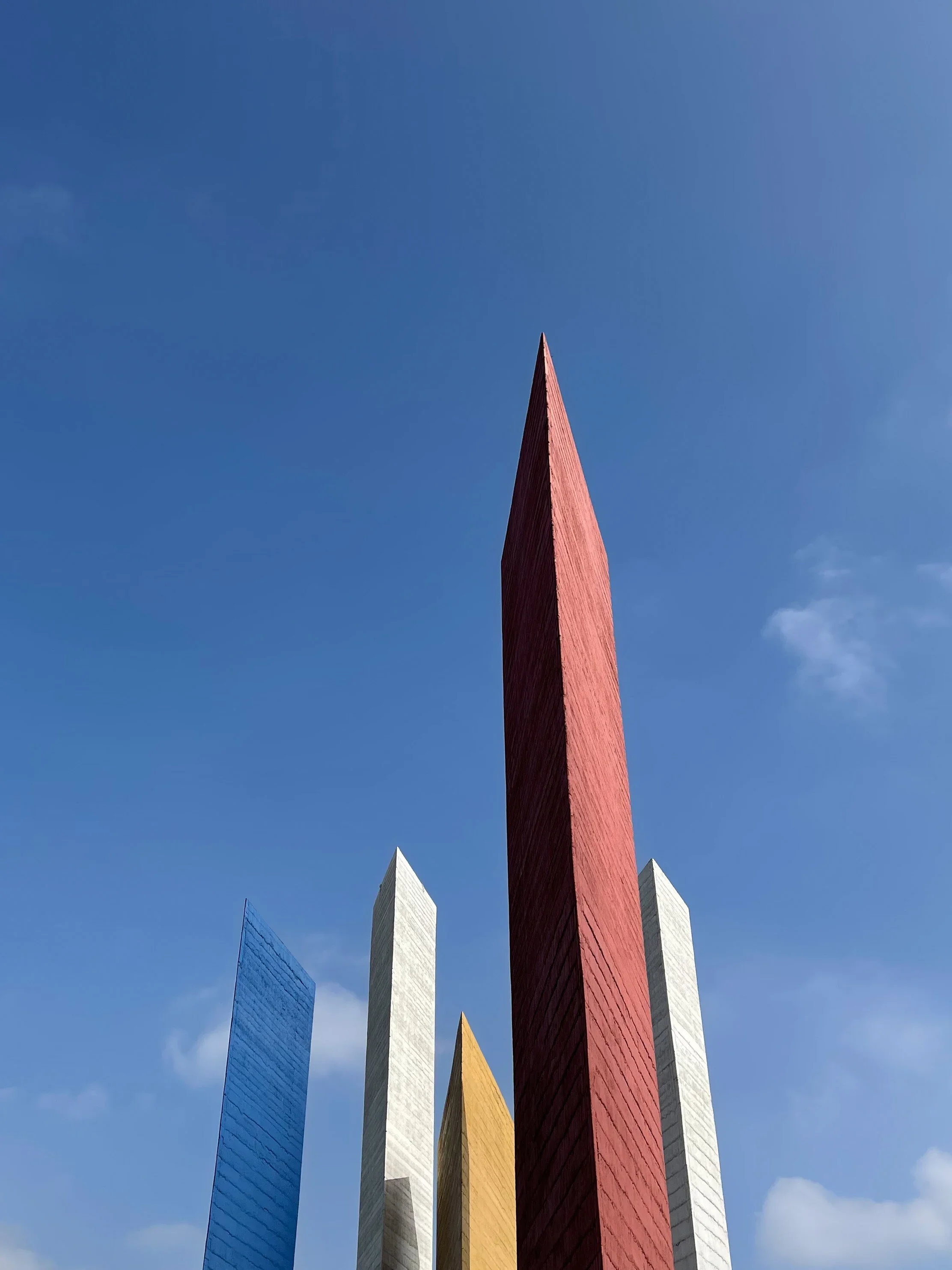 The blue, white, yellow and red thin sculptural Torres de Satélite by the architect Luis Barragán outside of CDMX
