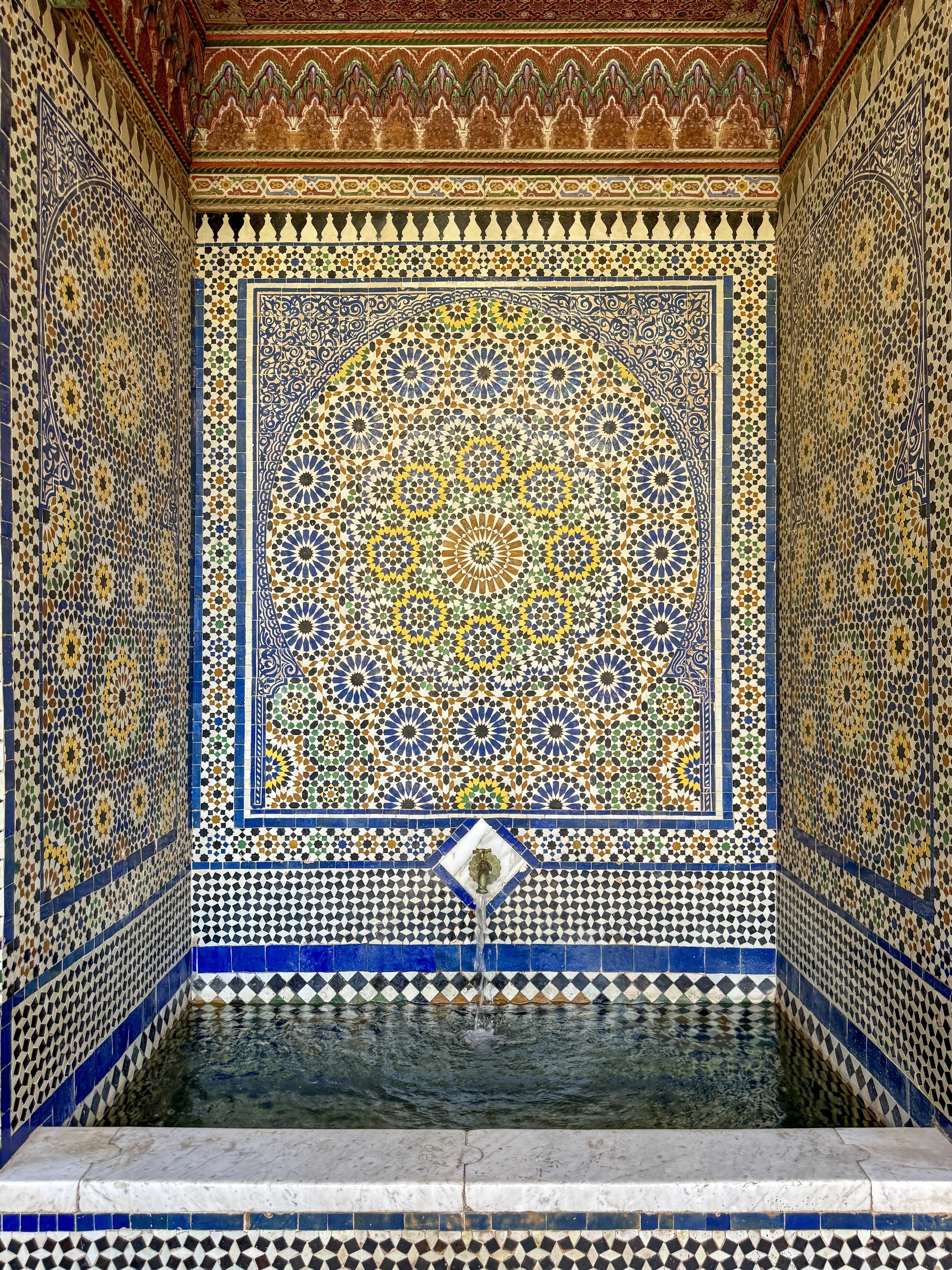 A water feature with elaborate zellige tiles at Dar el Bacha in Marrakech, Morocco