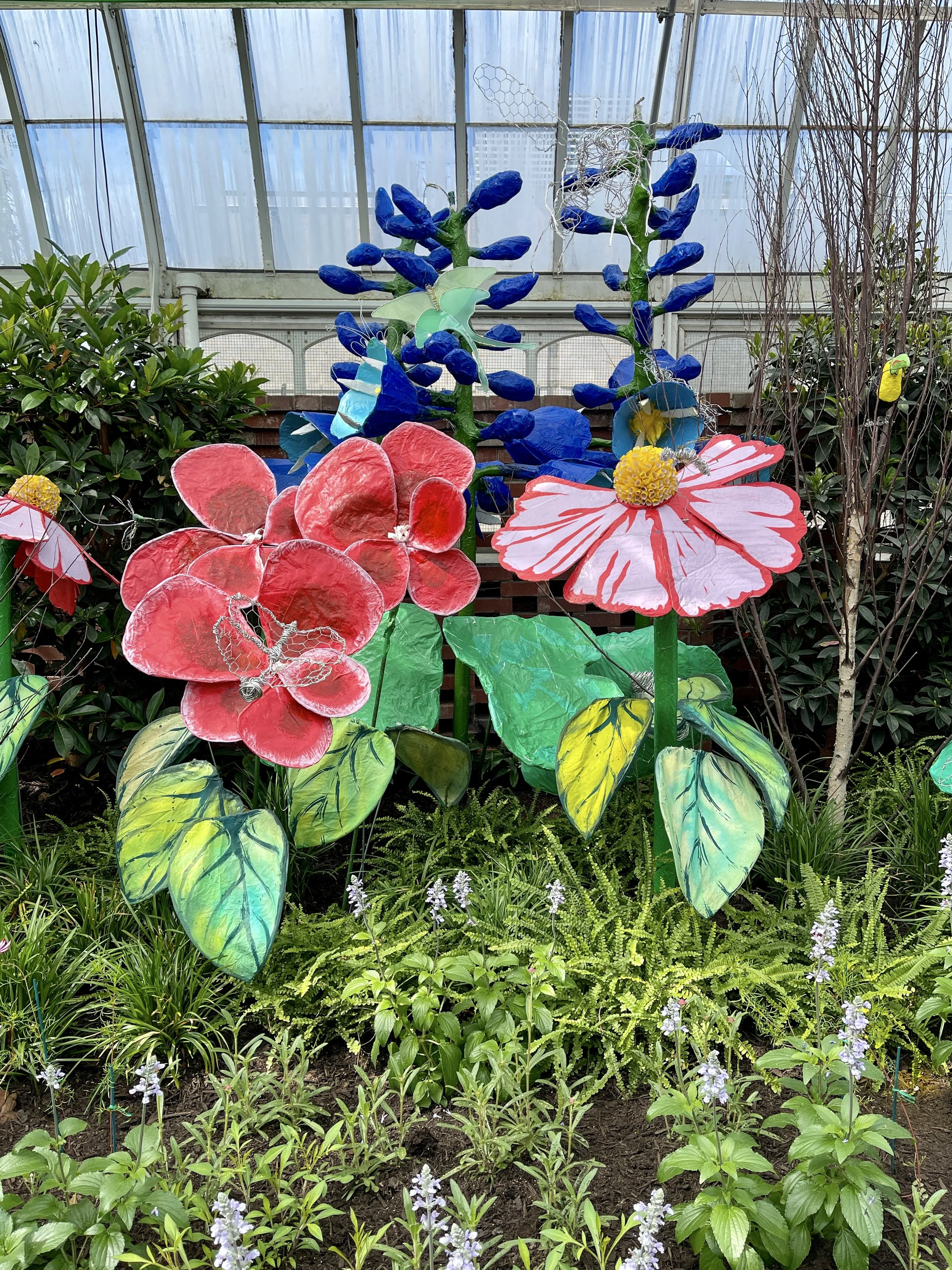 Large red and blue papier-mache flowers at the Phipps