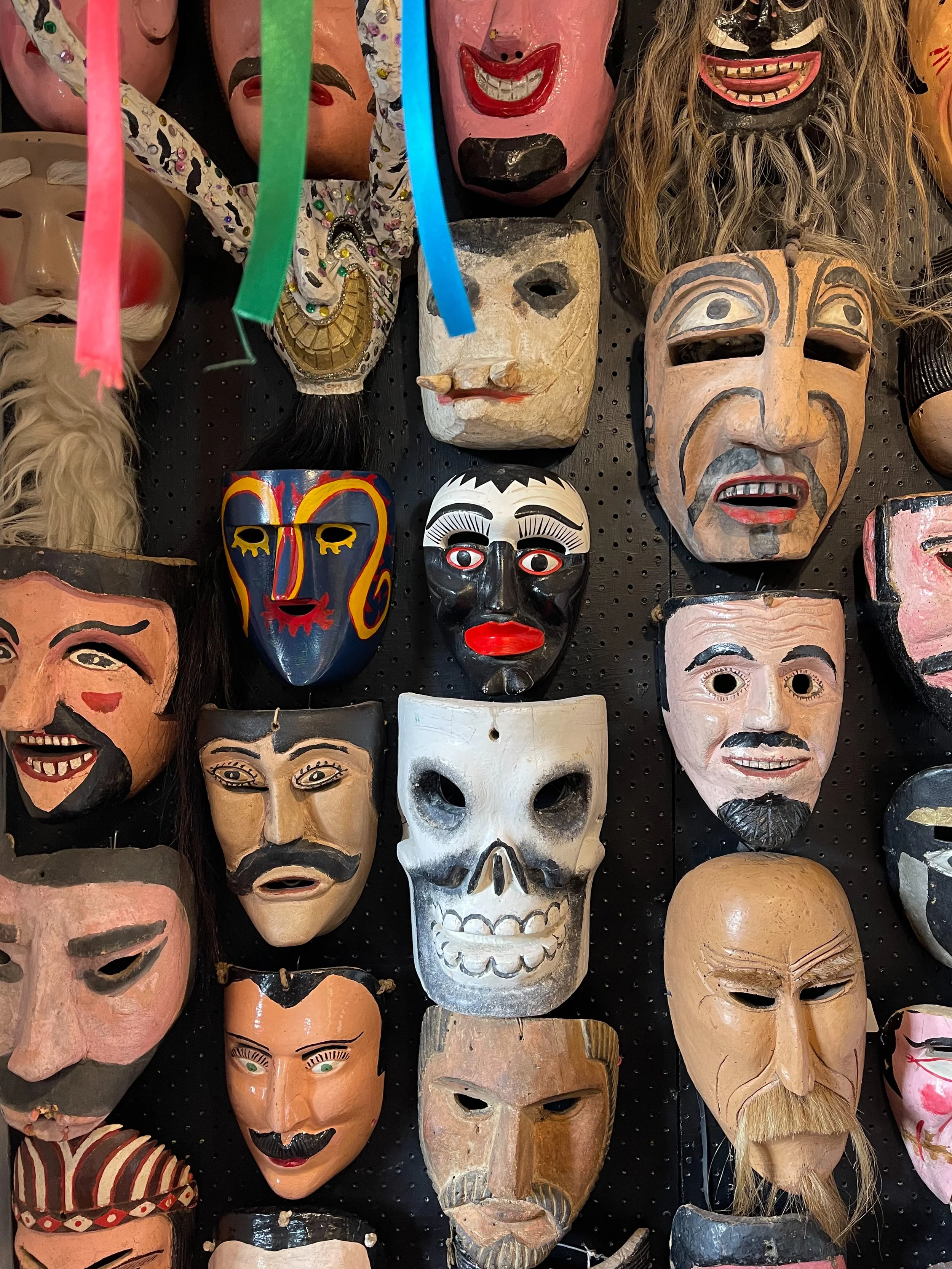 Painted masks for sale at the Bazar Sábado