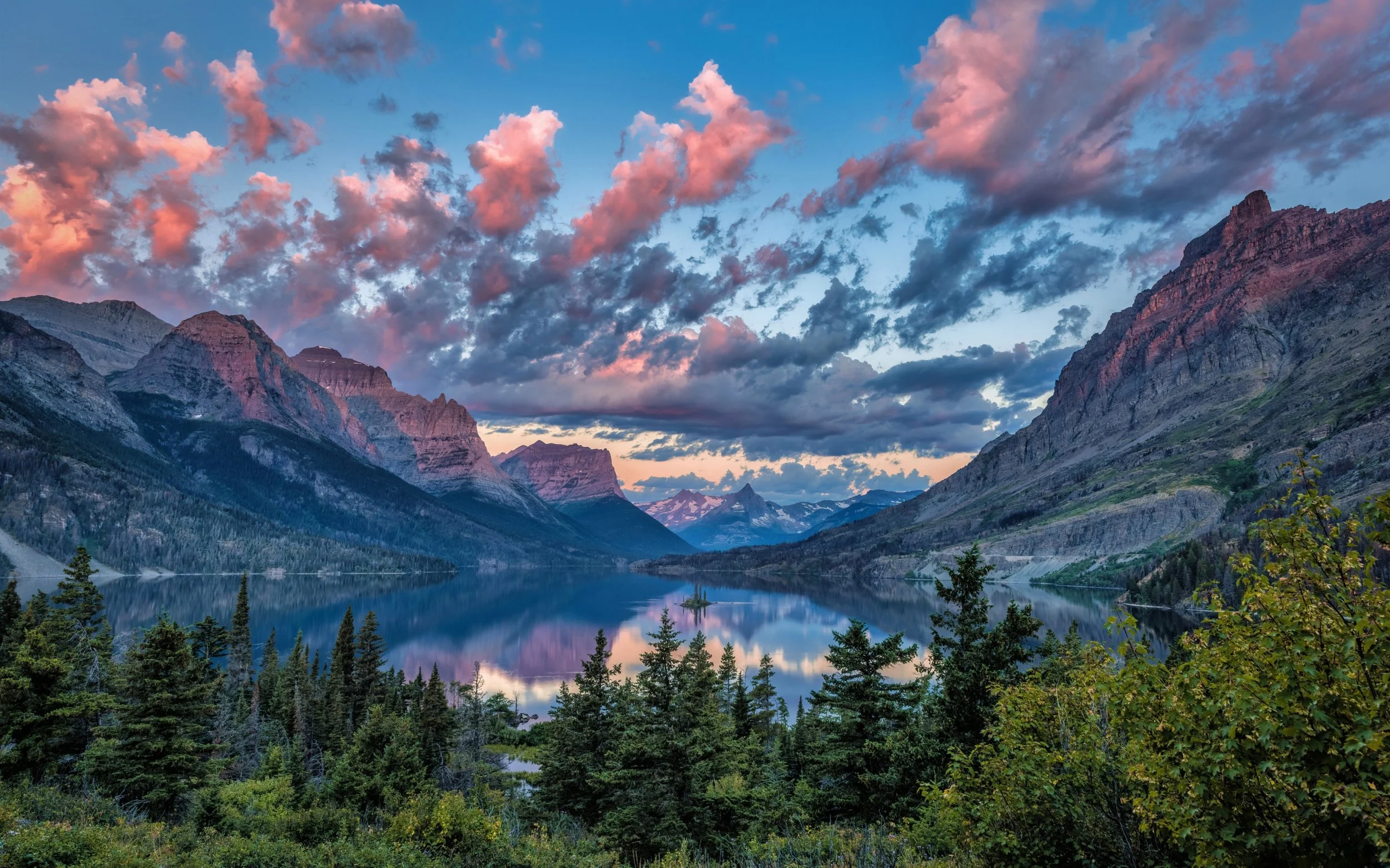 Dramatic mountains, clouds and trees at Saint Mary Lake, Montana, USA