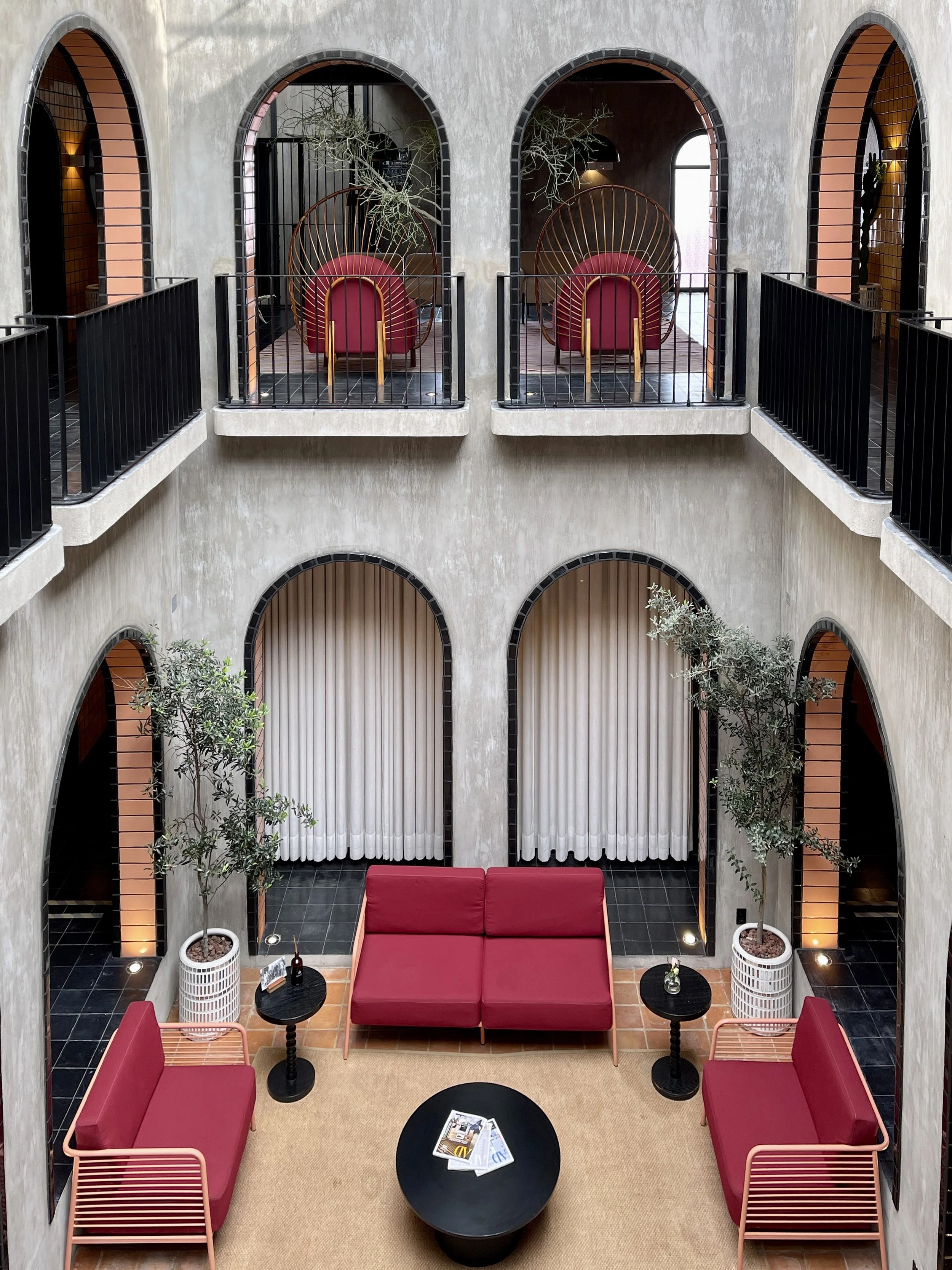 Looking down at the red couches in the lobby of Casa Hoyos in San Miguel de Allende