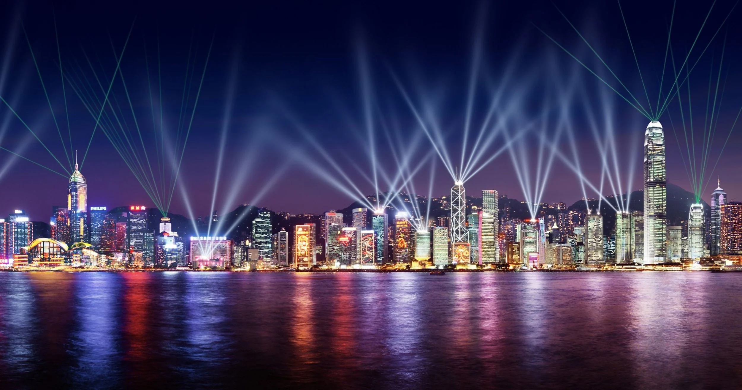 The Symphony of Lights, with white light beaming out of the skyscrapers of Hong Kong, seen across the water