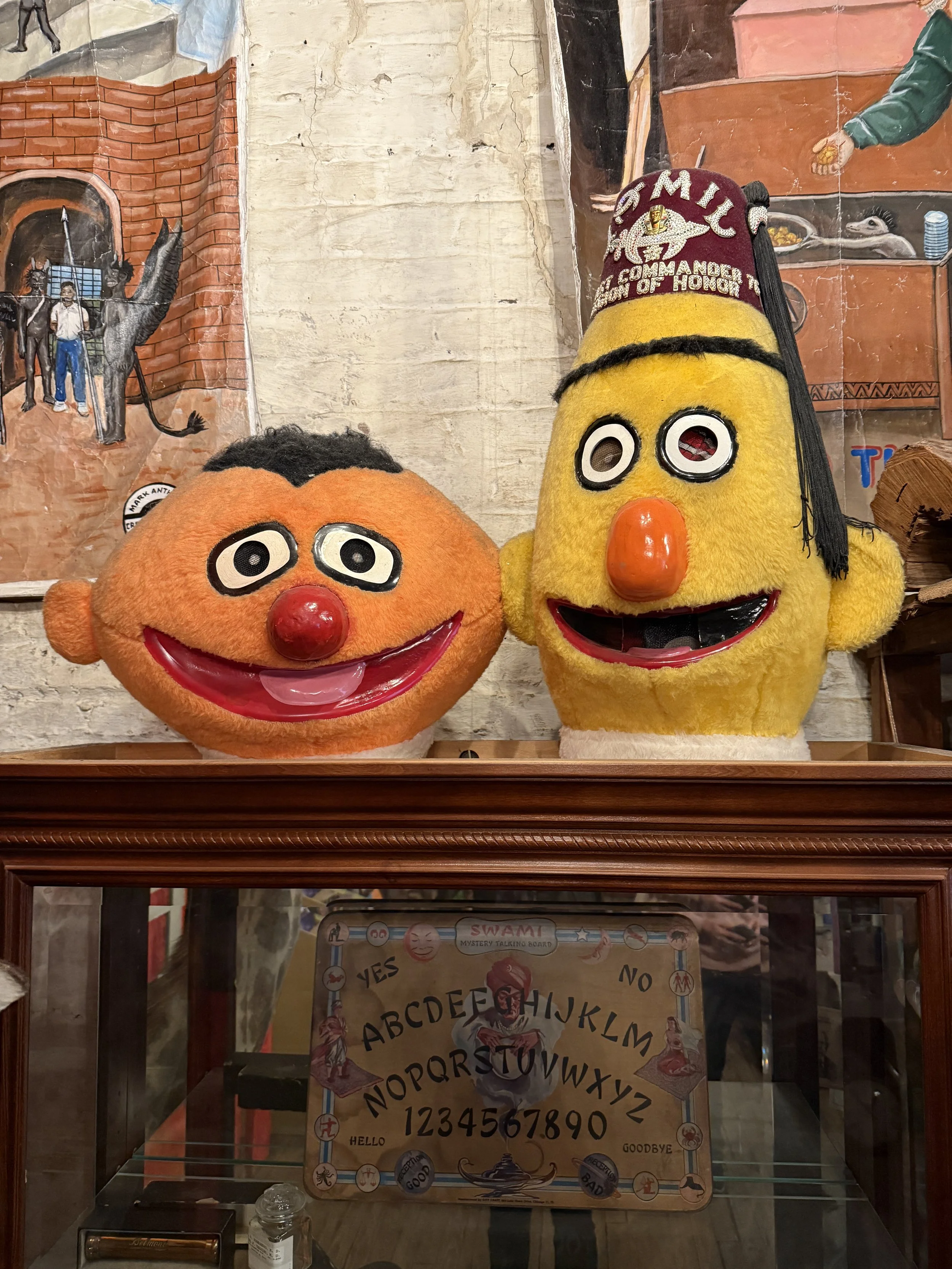 Old cloth masks of Ernie and Bert (wearing a fez) from Sesame Street at the Graveface Museum gift shop in Savannah, GA