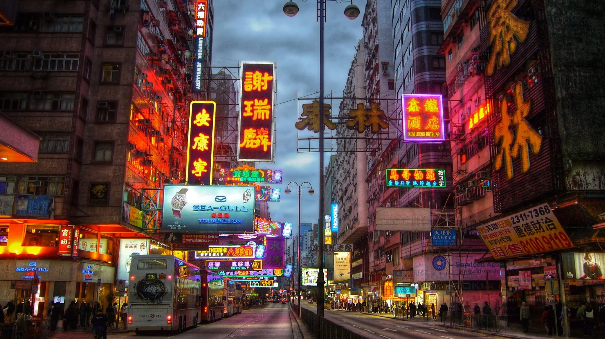 Neon signs light up a street in the Kowloon district of Hong Kong