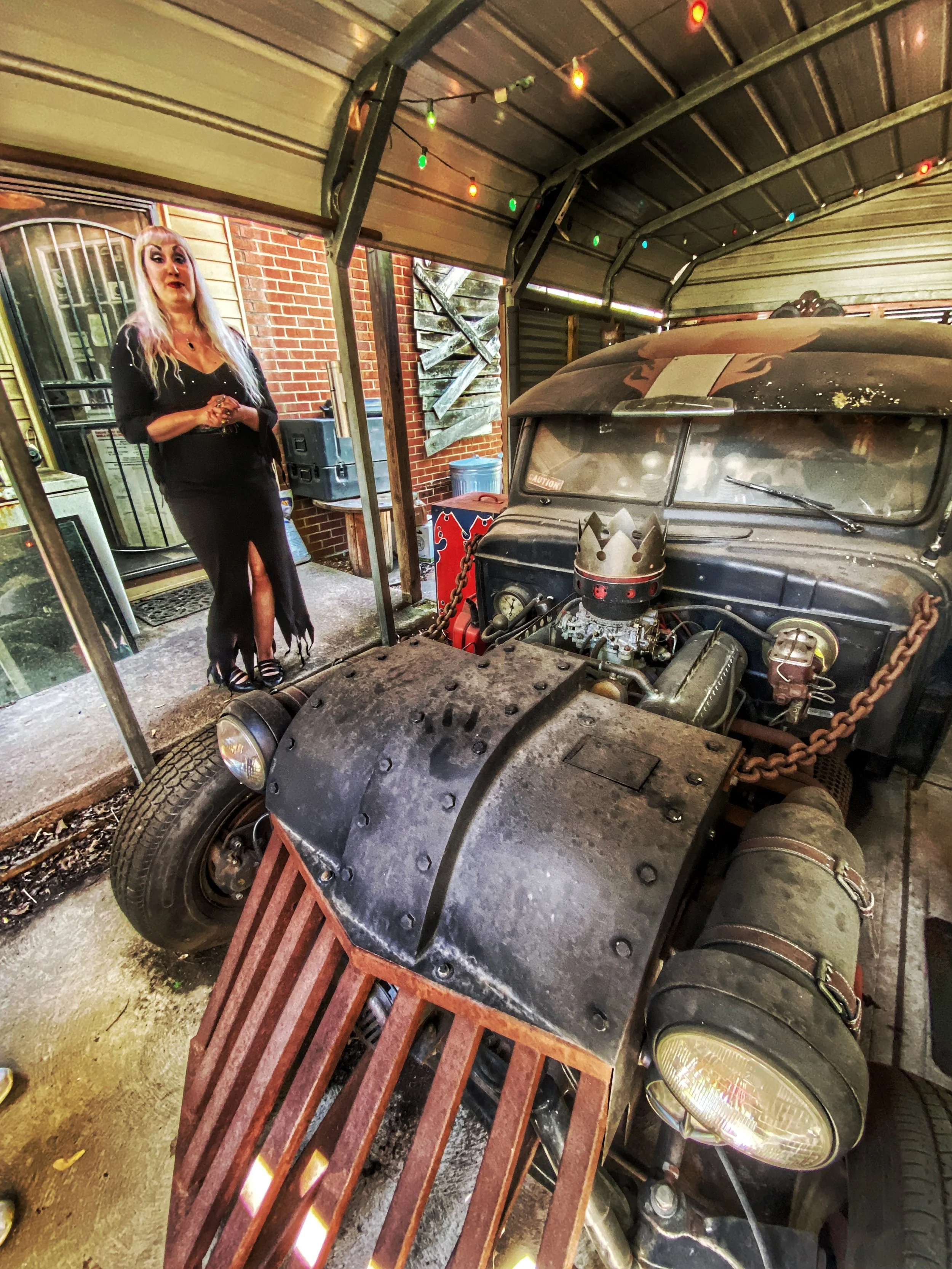 Velda von Minx by one of her husband's vamped-up cars like something out of Tarantino's Death Proof