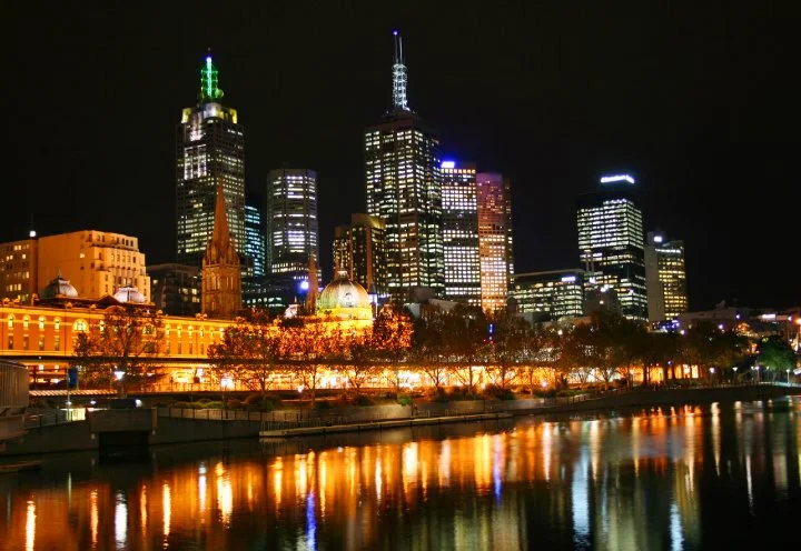 Melbourne, Australia skyline at night, with lights reflecting on the water