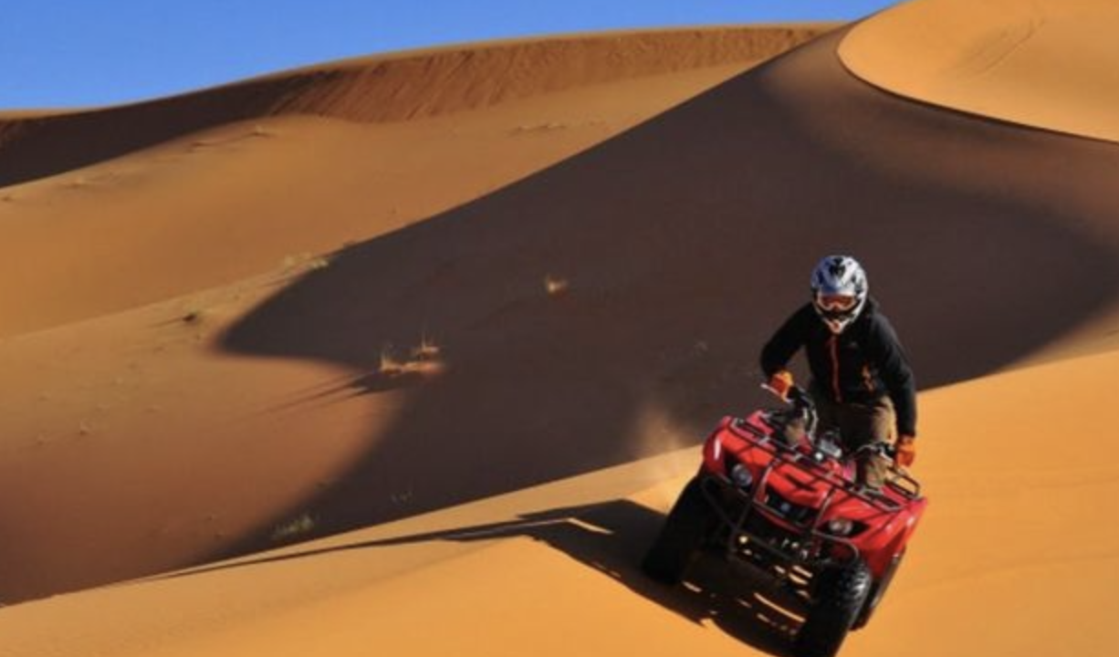 Four-wheeler on the dunes of Sahara el Beyda desert in Egypt