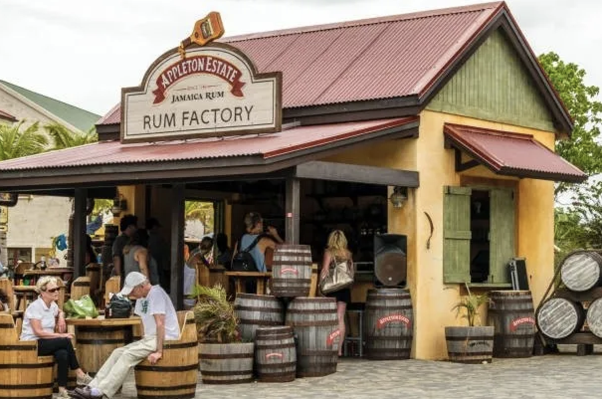 A couple sits on barrels outside the Appleton Estate Rum Factory in Jamaica