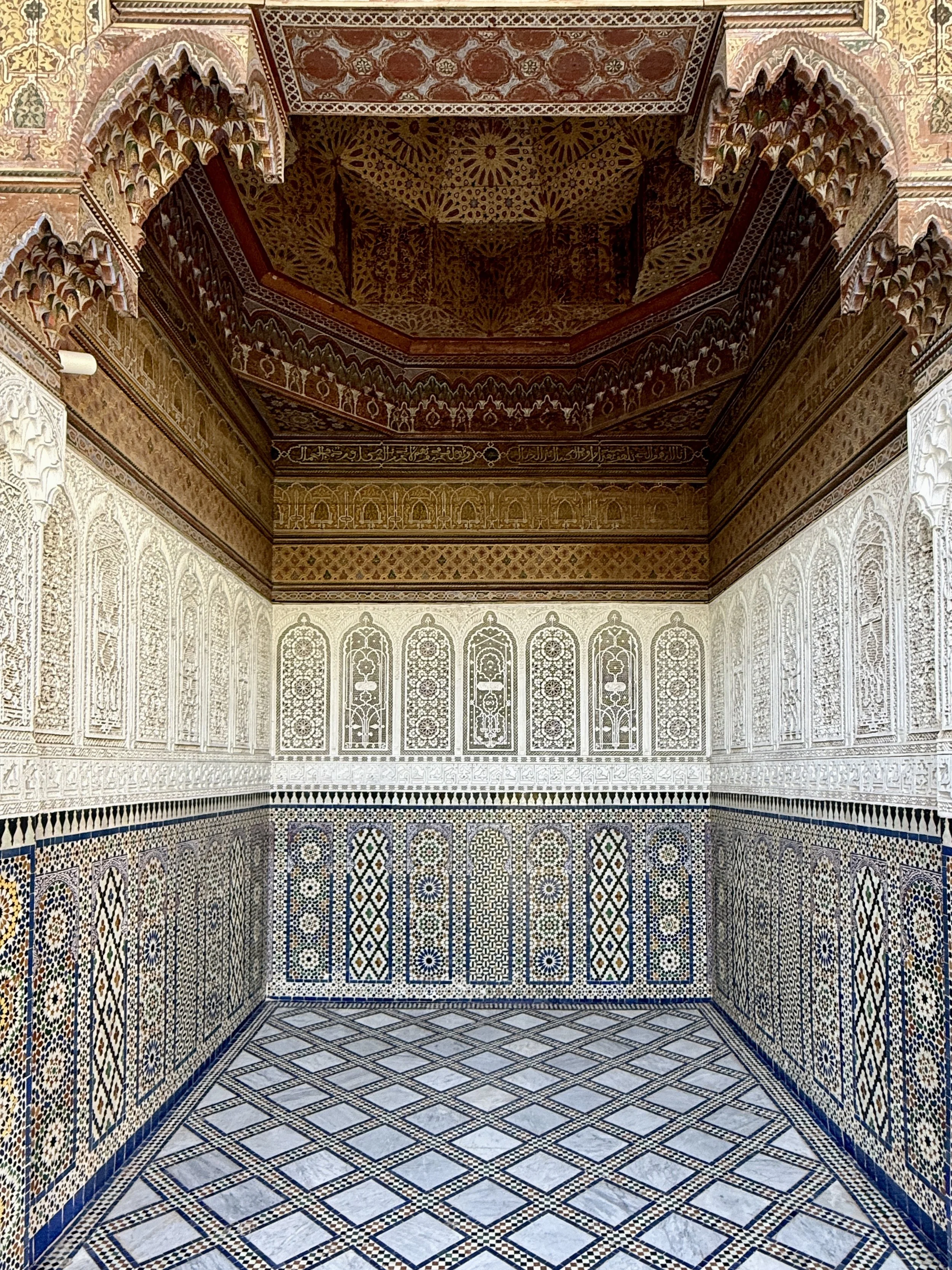 One of the niches off of the courtyard at Dar el Bacha, Marrakech, Morocco, with gorgeous tilework and carved ceiling
