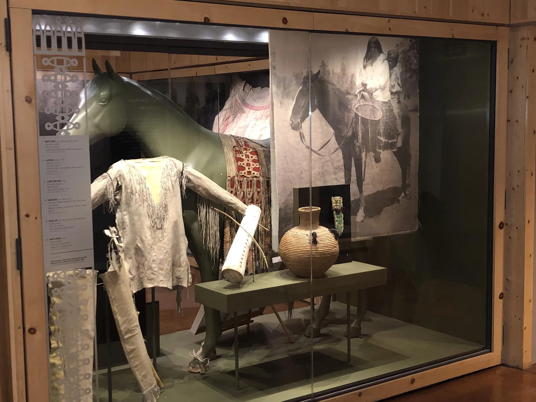 Apache artifacts, including a shirt and bowl, on display at the Apache Cultural Museum in Arizona