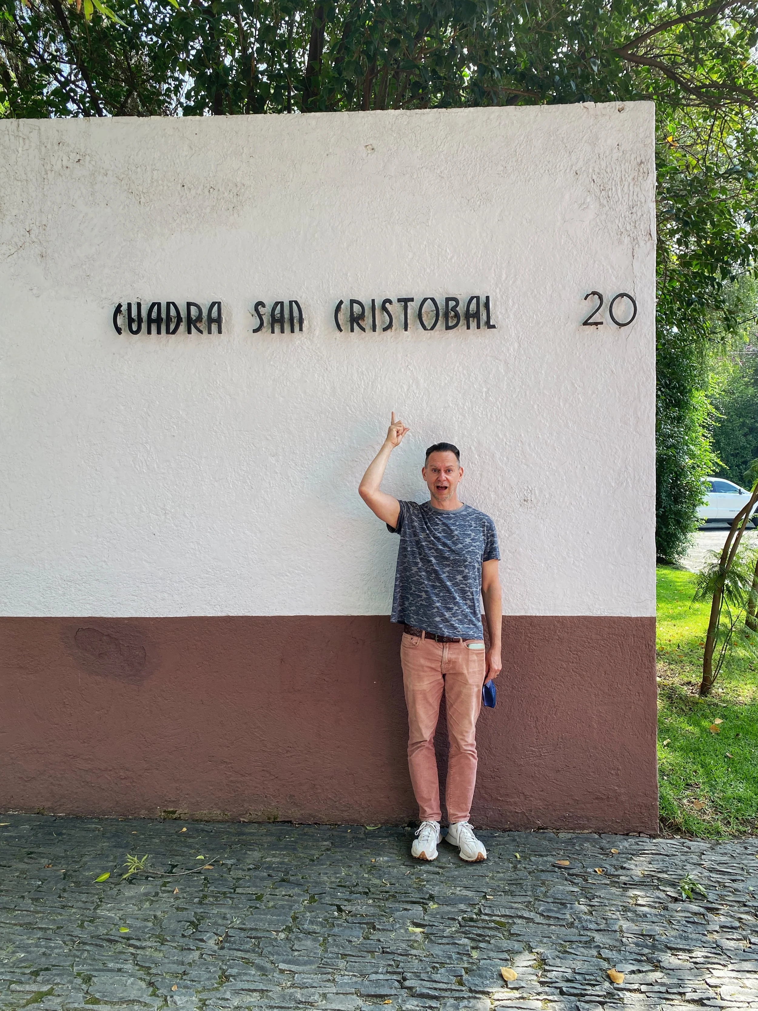 Duke pointing to the sign of Cuadra San Cristobal