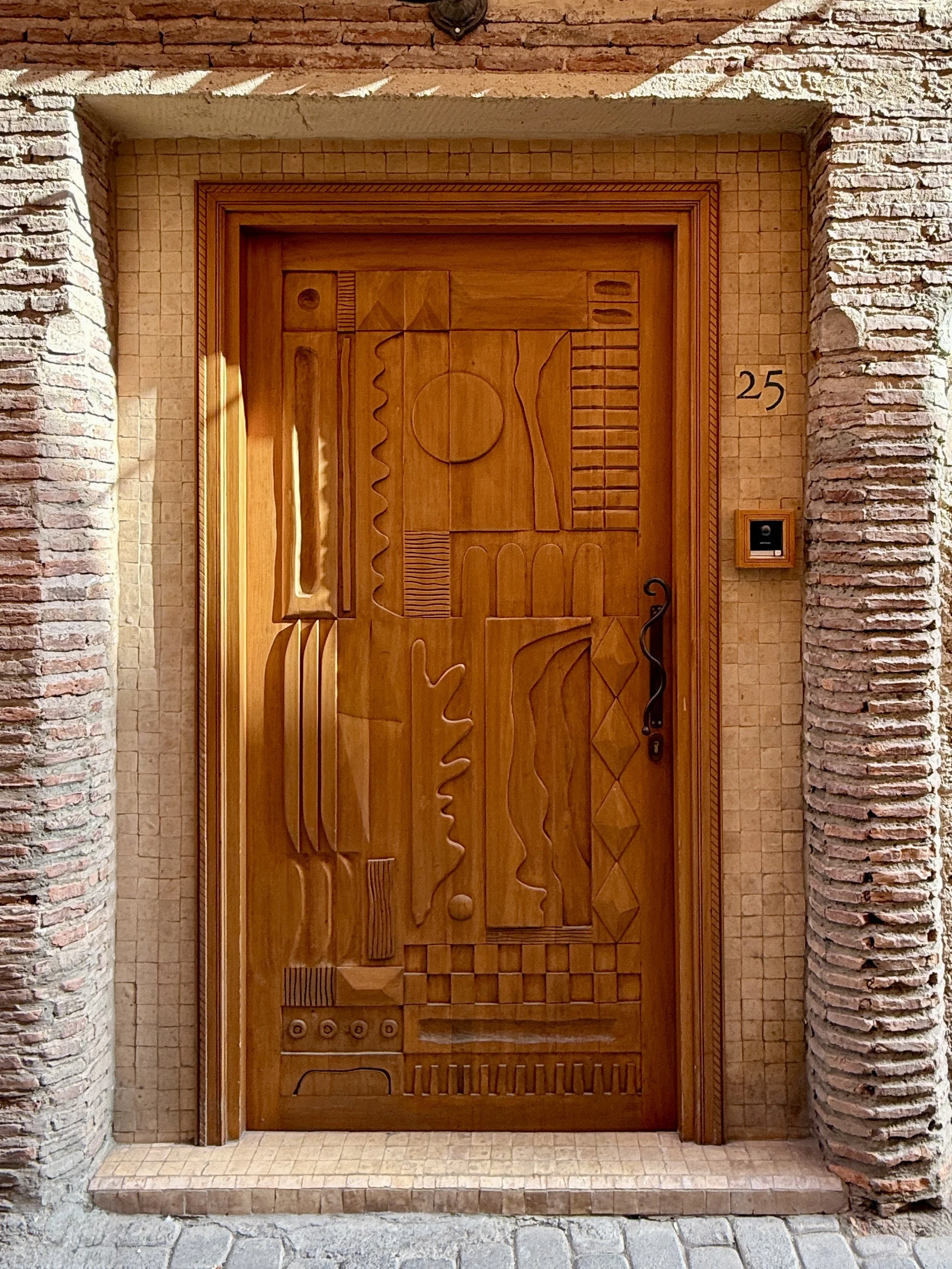 The elaborately carved cedarwood door at Riad Rosemary in Marrakech, Morocco