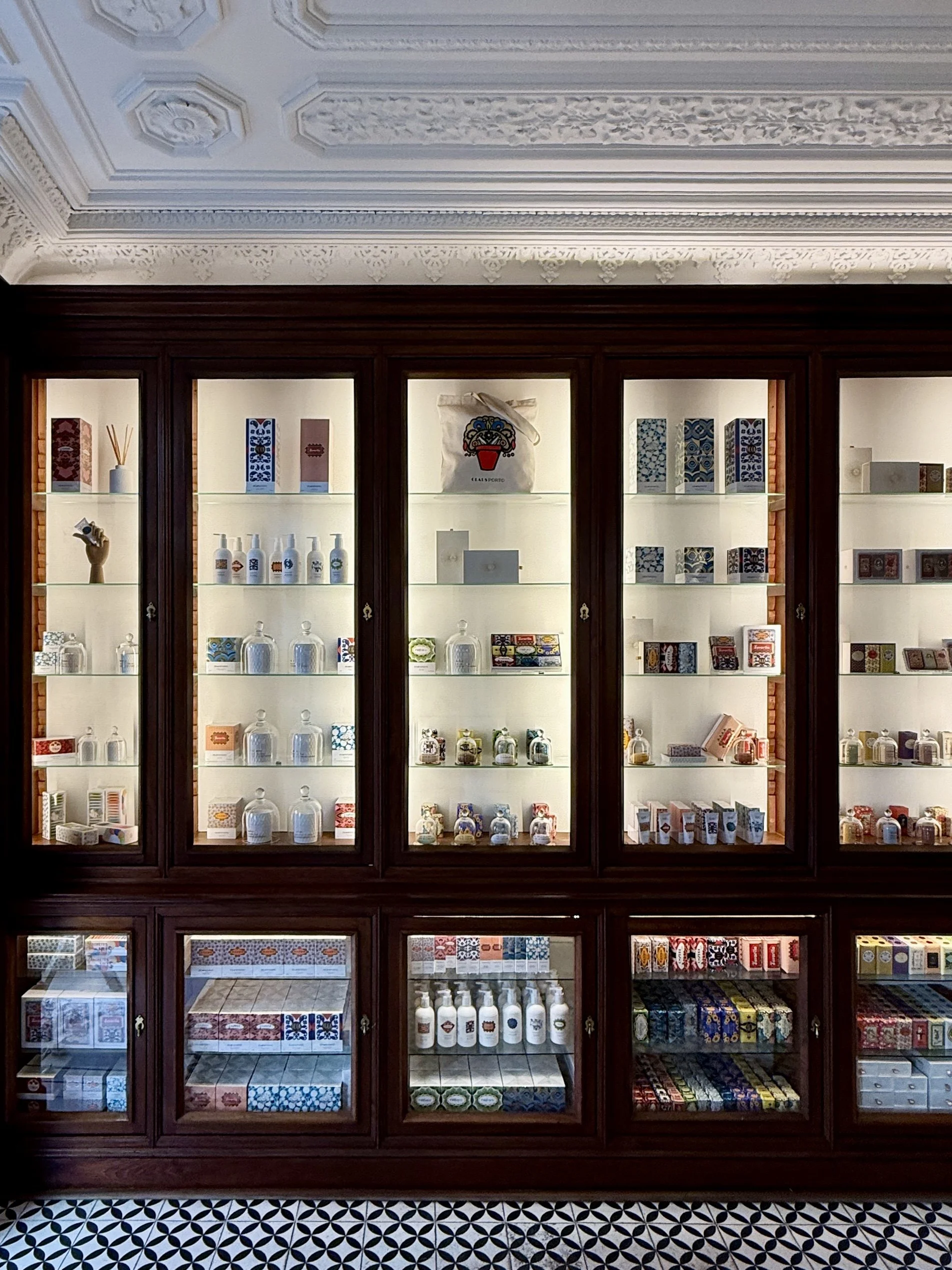 The original wood and glass cabinets that line the walls are a remnant of the space’s former life as a pharmacy, now showcasing Claus Porto’s distinctive soaps and toiletries.