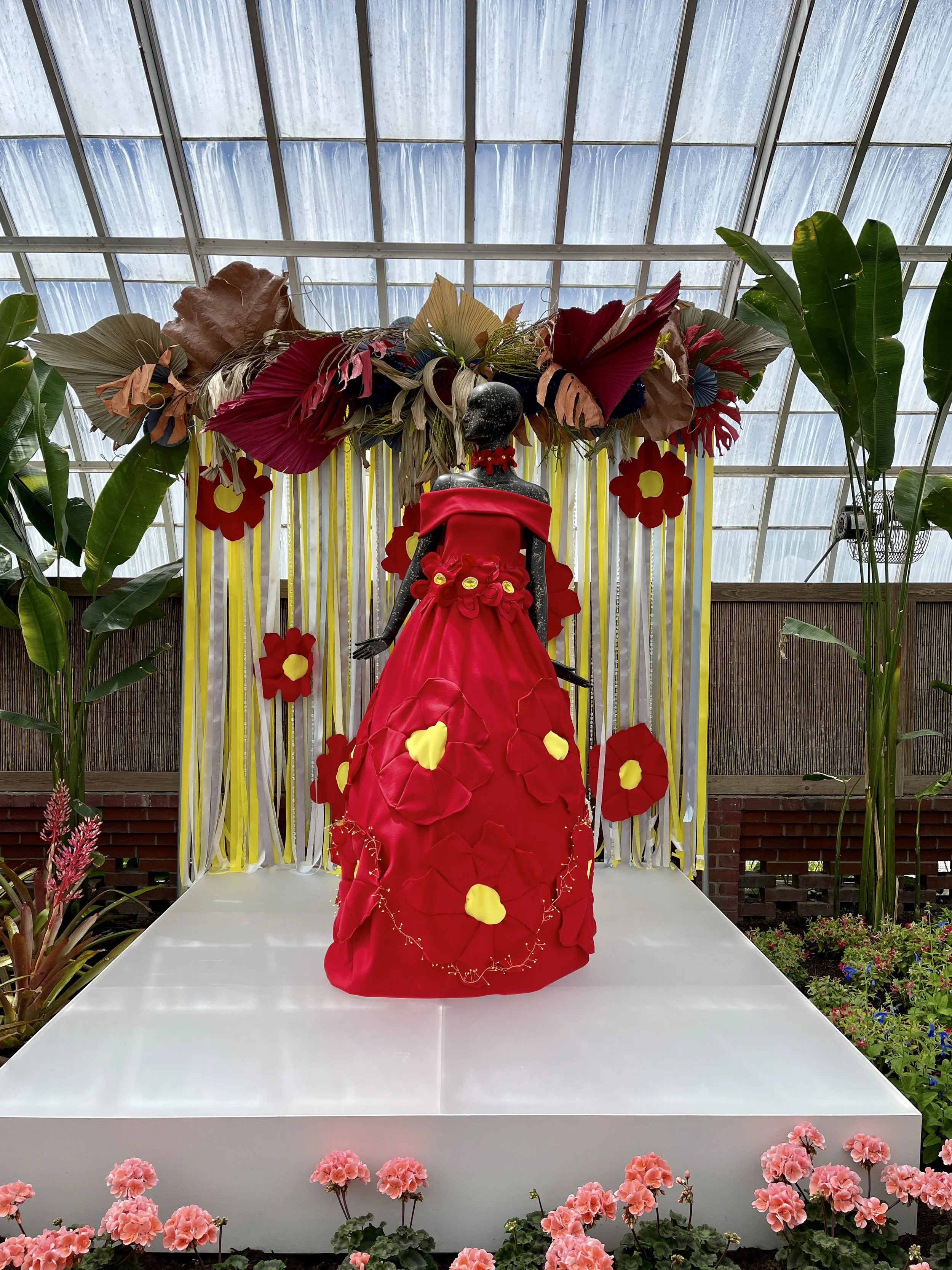 Red dress with large flowers on mannequin in Serpentine Room at the Phipps
