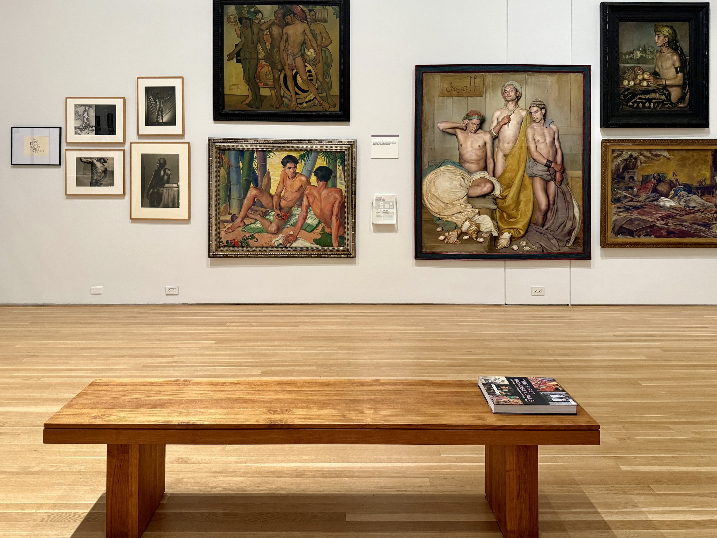 One of the gallery walls with a bench at The First Homosexuals exhibit at Wrightwood 659 in Chicago