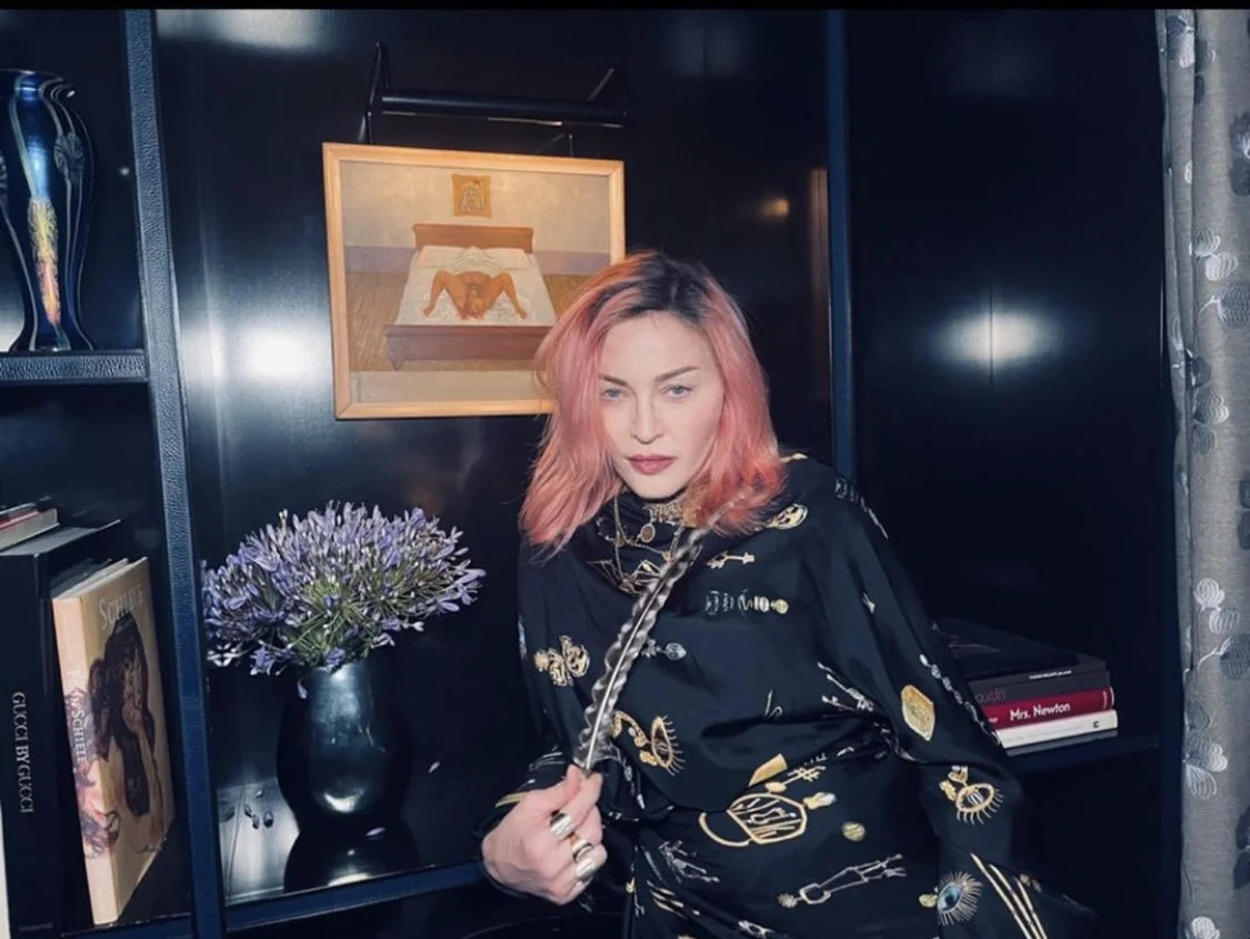 Madonna in front of her painting My Birth by Frida Kahlo