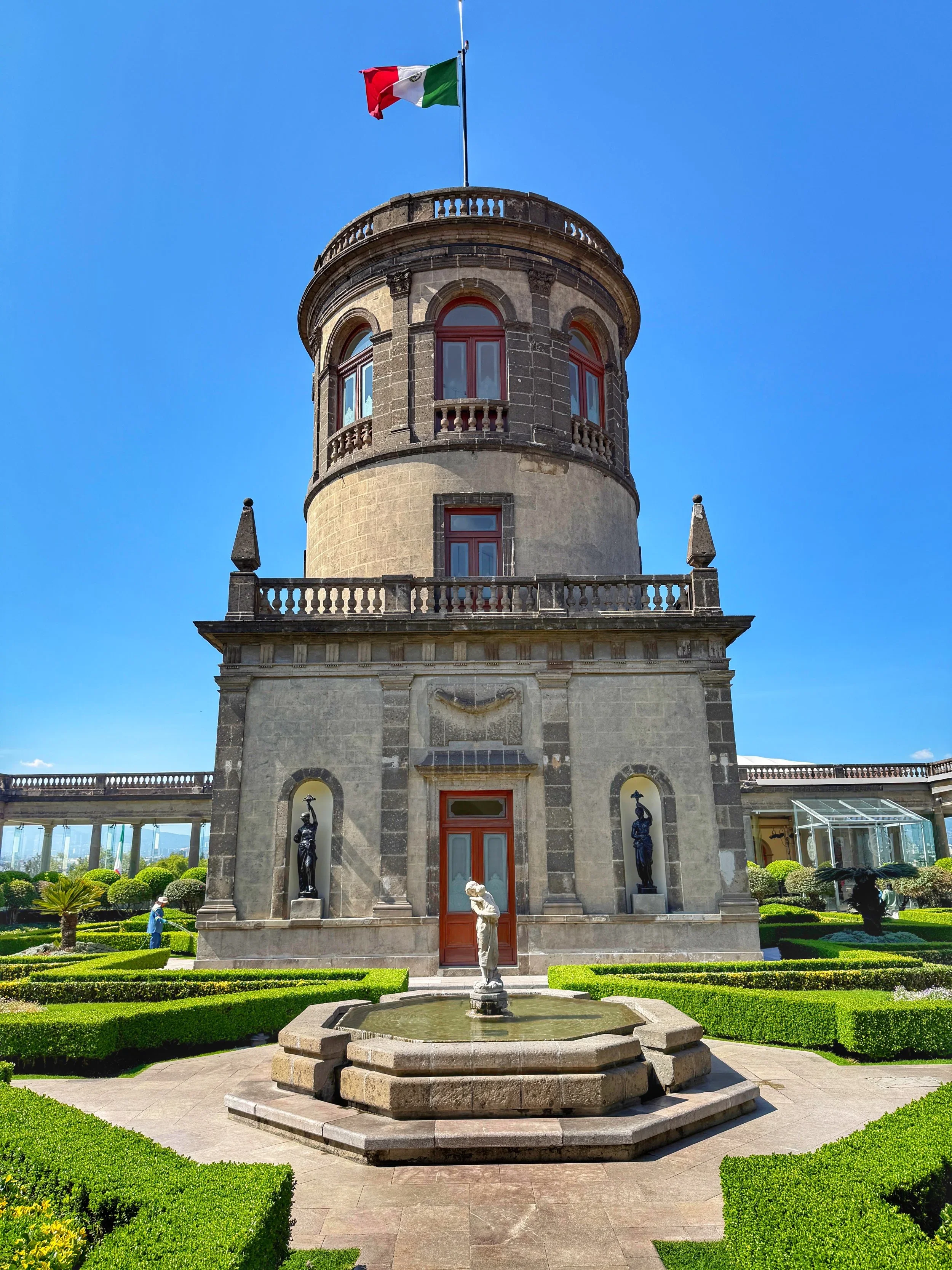 The rooftop garden and observatory tower by a fountain and hedges in Mexico City's Chapultepec Castle