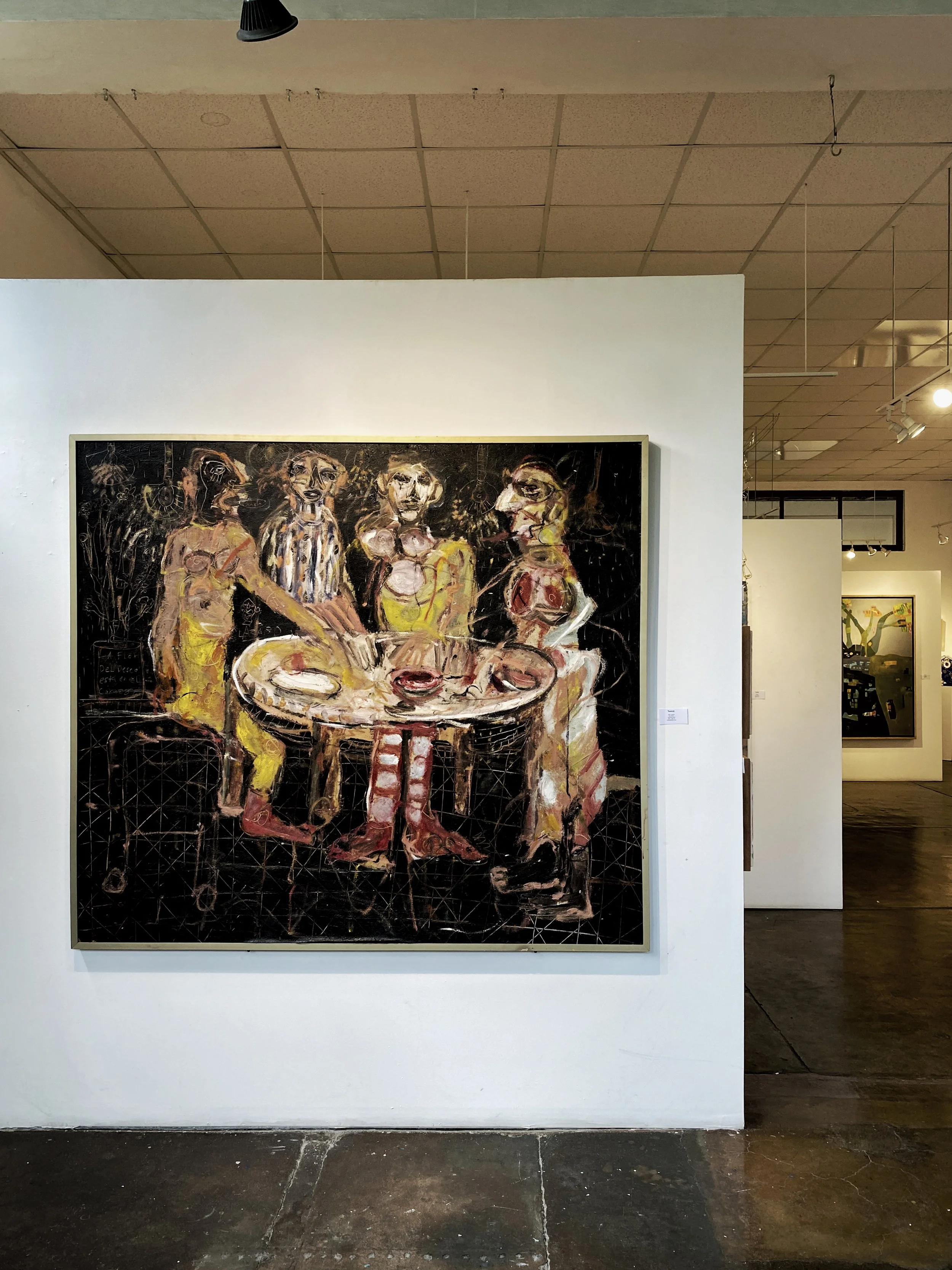 Painting of people around a table at Manuk Gallery in San Miguel de Allende