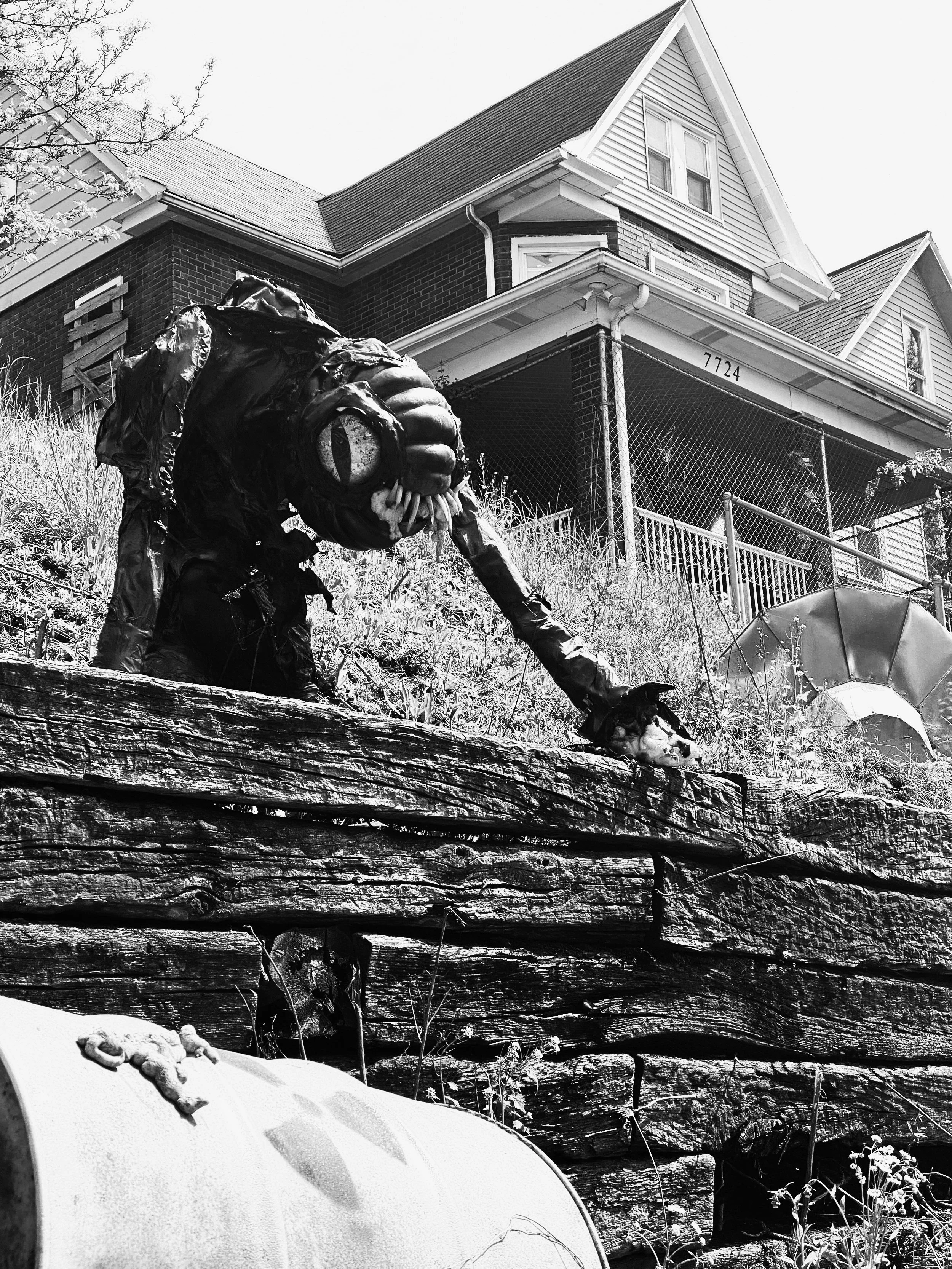 Trundle Manor with yellow-eyed, fanged alien creature out front