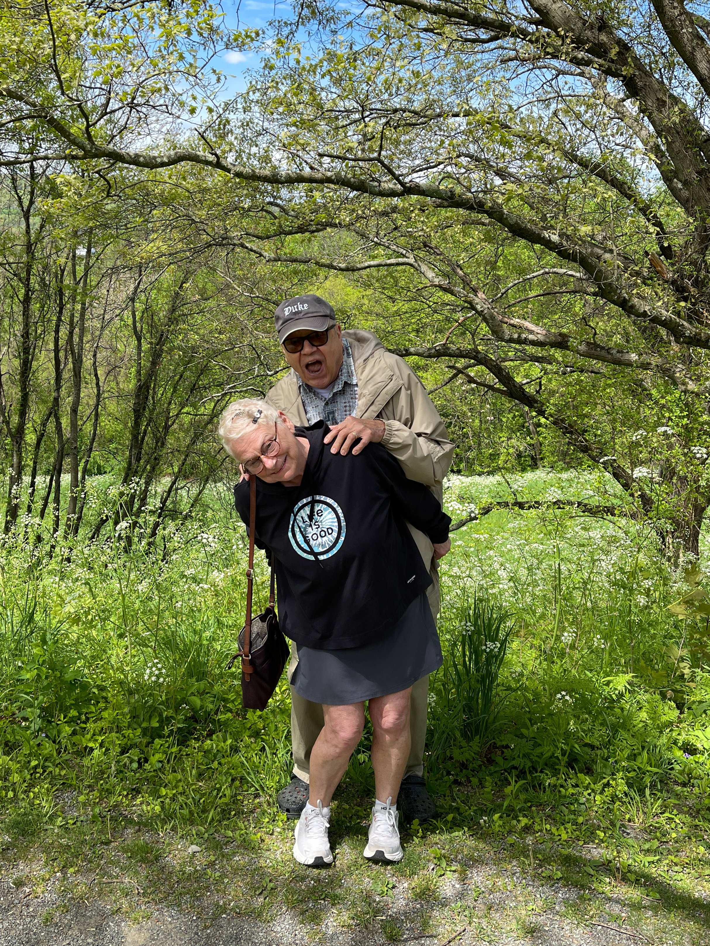 A man and woman goof off in the woods next to the Vanderbilt Mansion