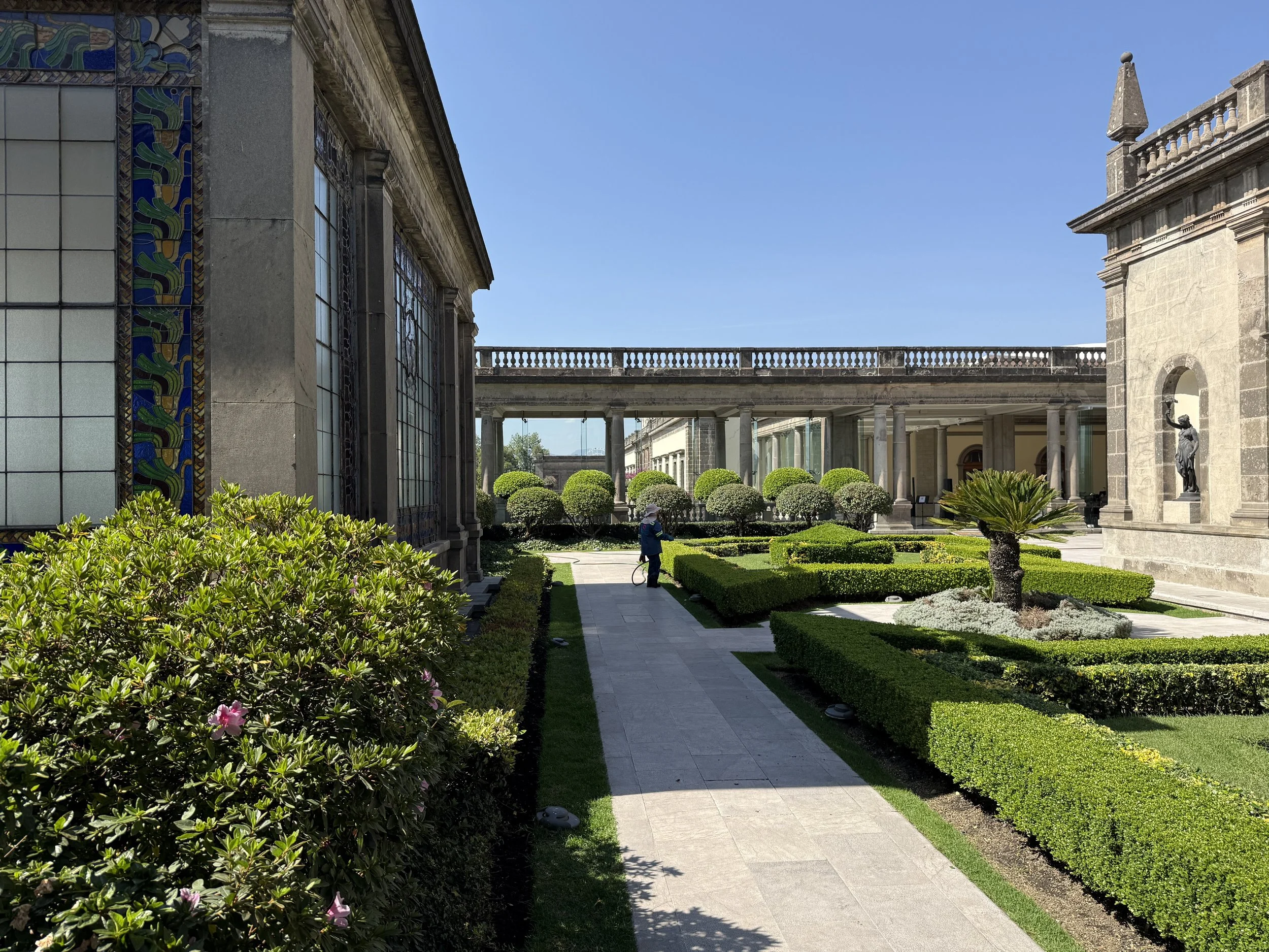 A walkway beyond hedges in the rooftop garden of Chapultepec Castle