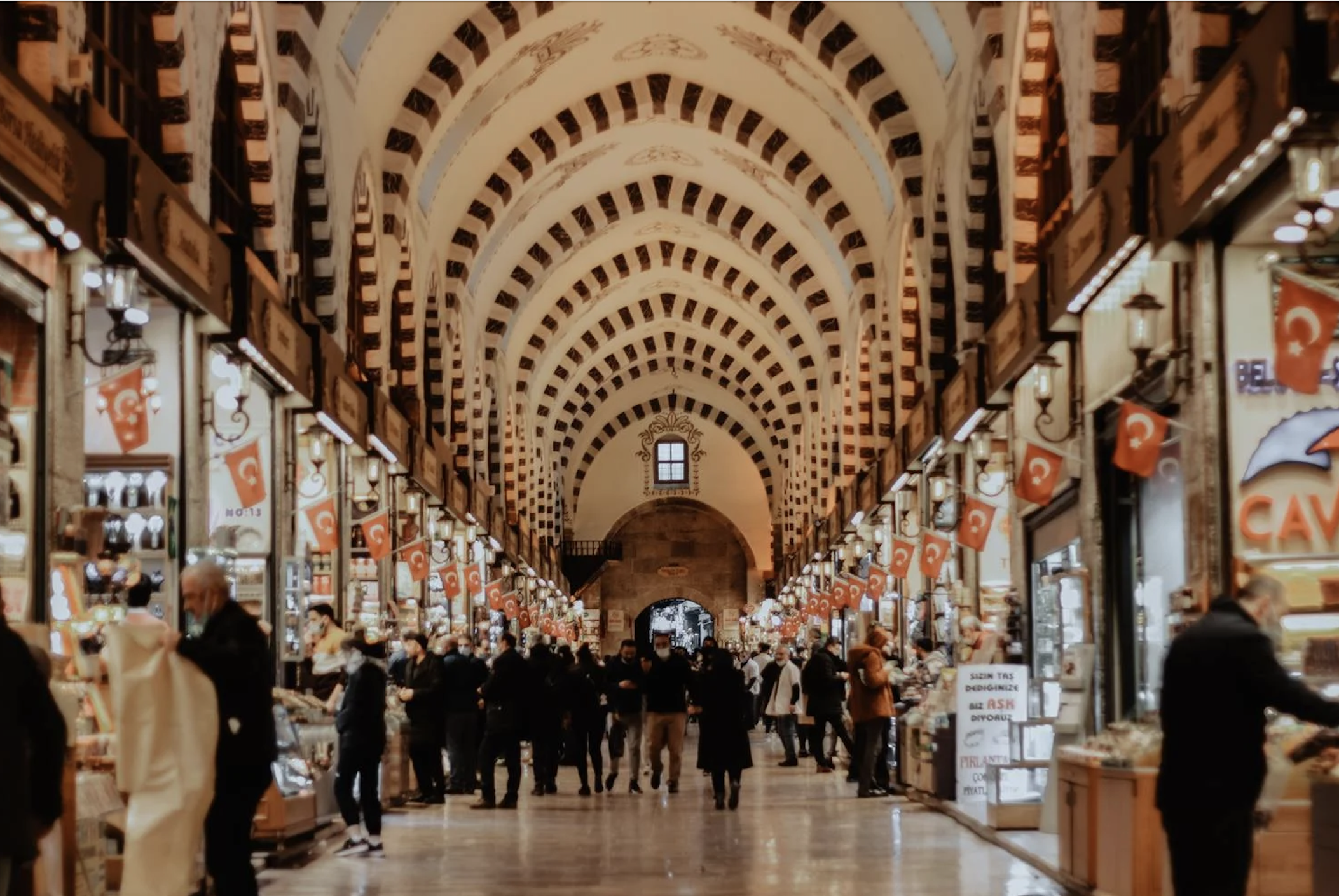 Red and white arches and lines of stalls inside the Grand Bazaar in Istanbul, Turkey
