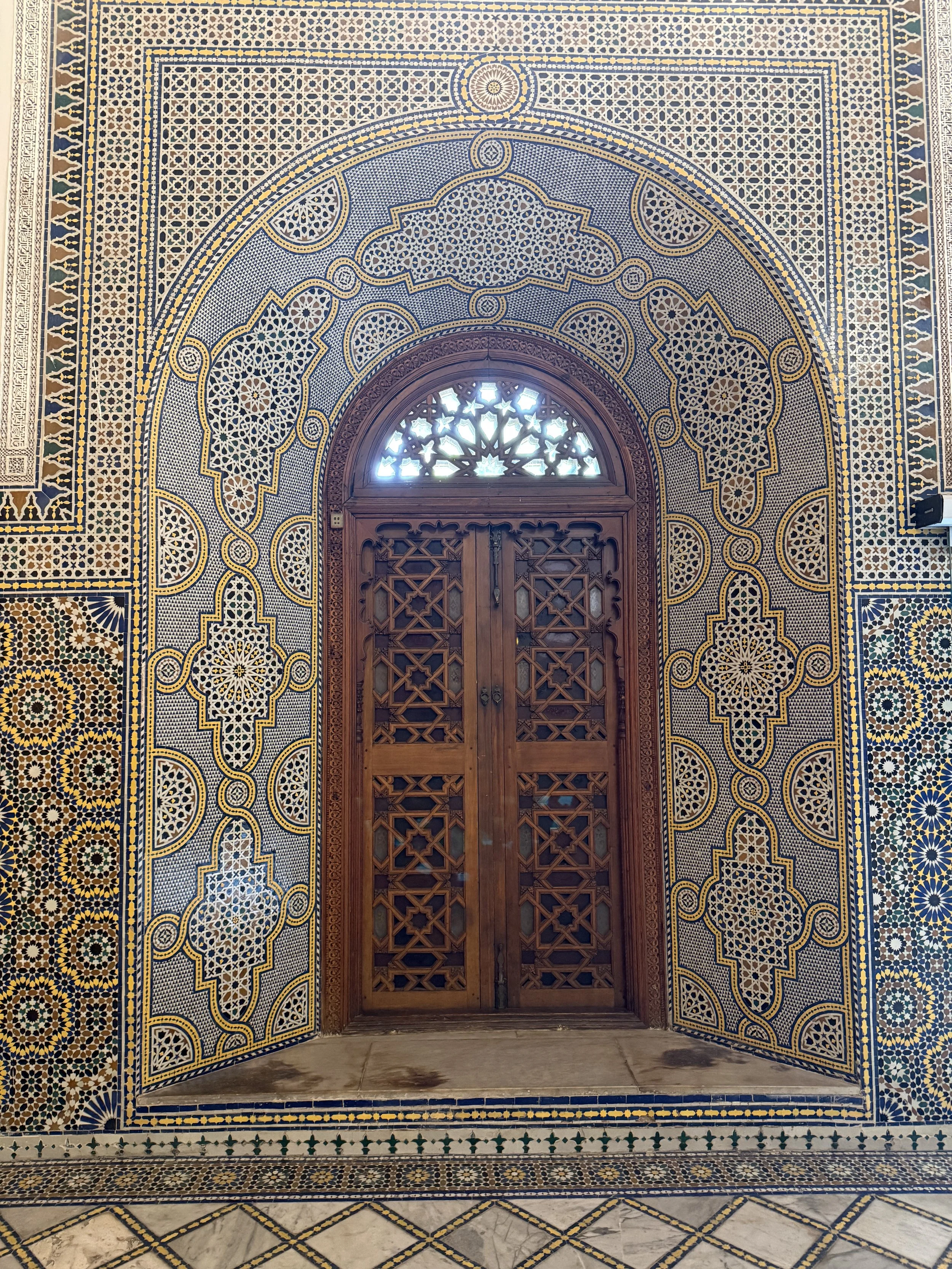Cedarwood widow screen and zellige tile at Dar el Bacha, Marrakech, Morocco